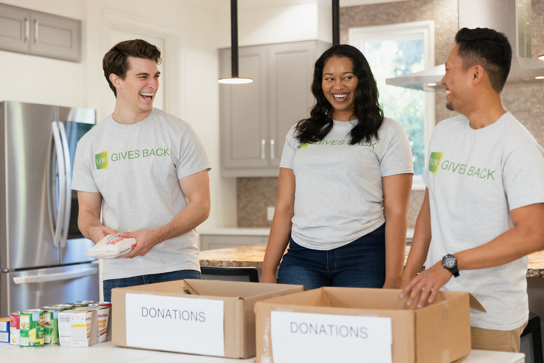 three people sorting donations into boxes