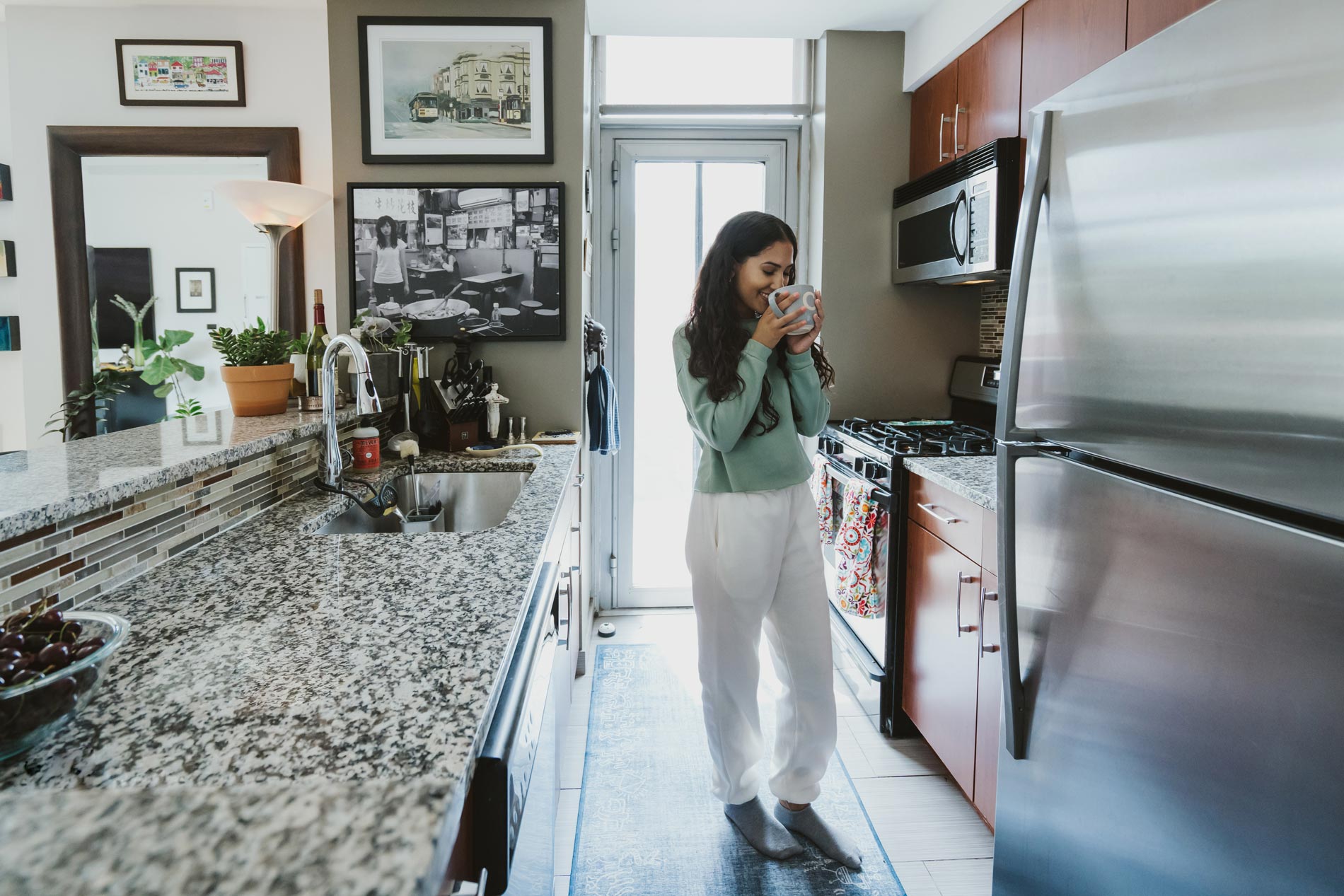 21 Chelsea woman with coffee in staged kitchen