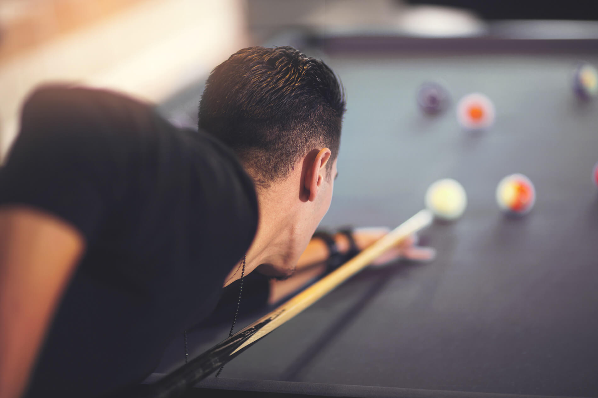 man goes for a shot on a pool table