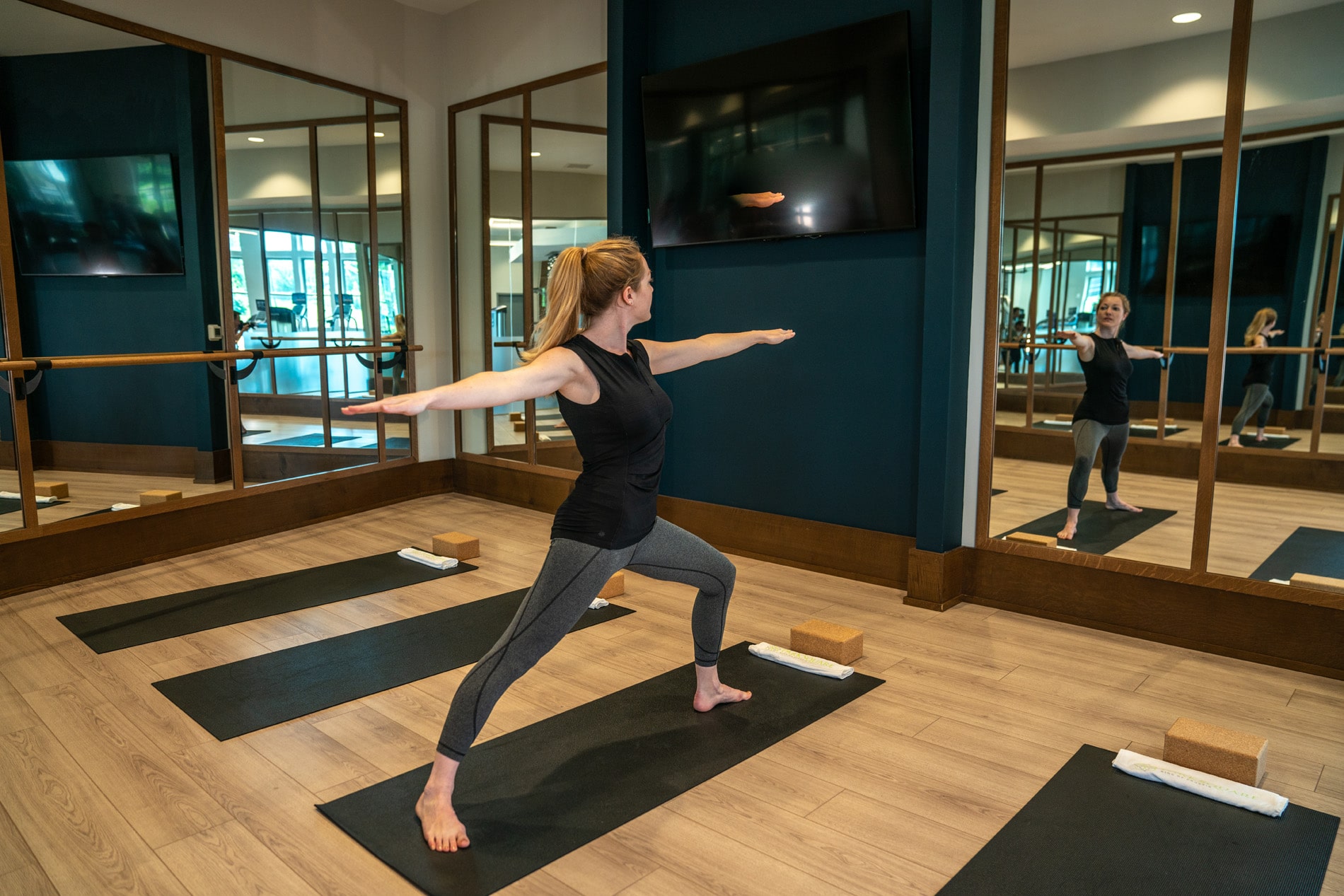 Woman holding yoga pose in yoga studio