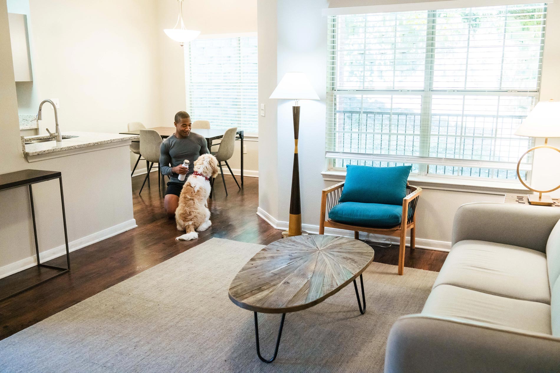 Preserve at Brentwood man and dog in apartment living room