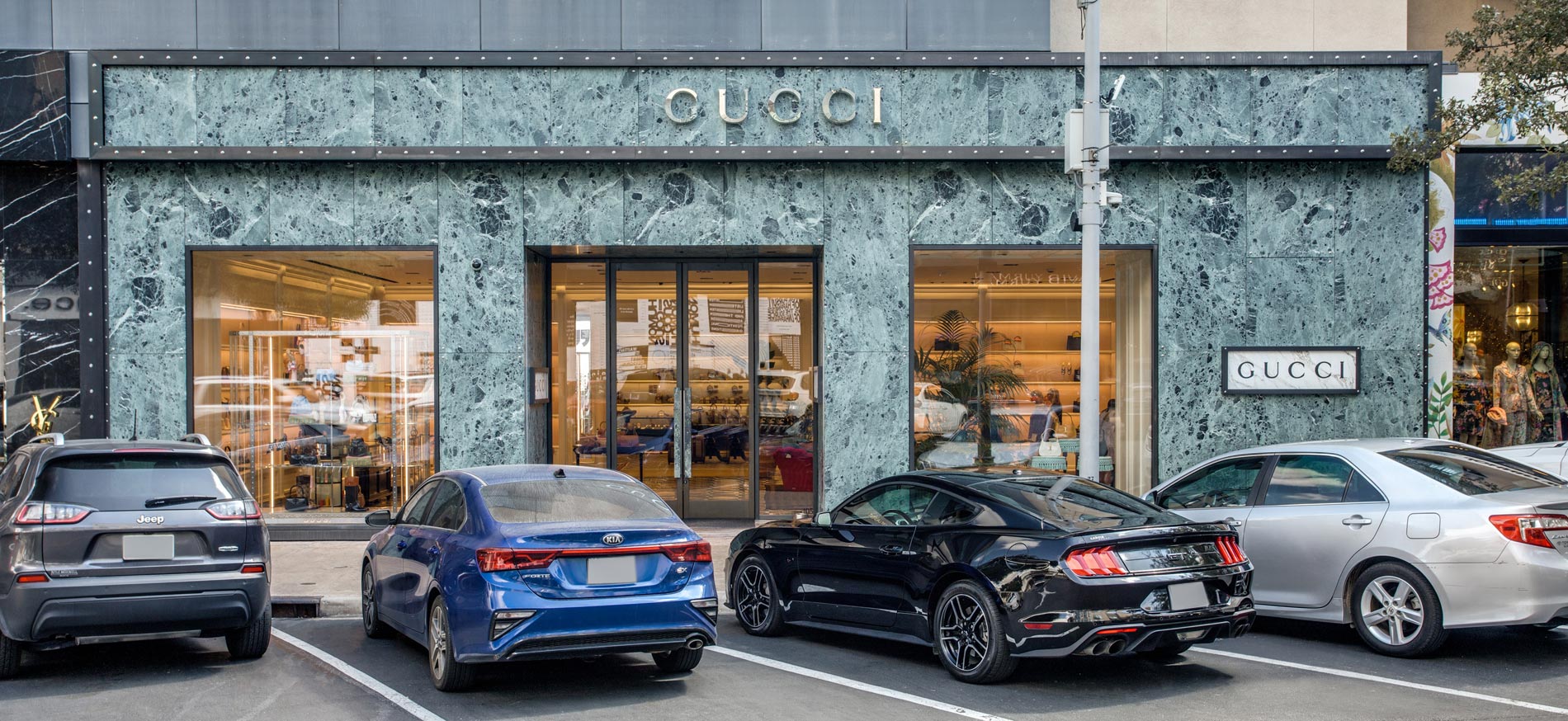 Cars parked in front of Gucci