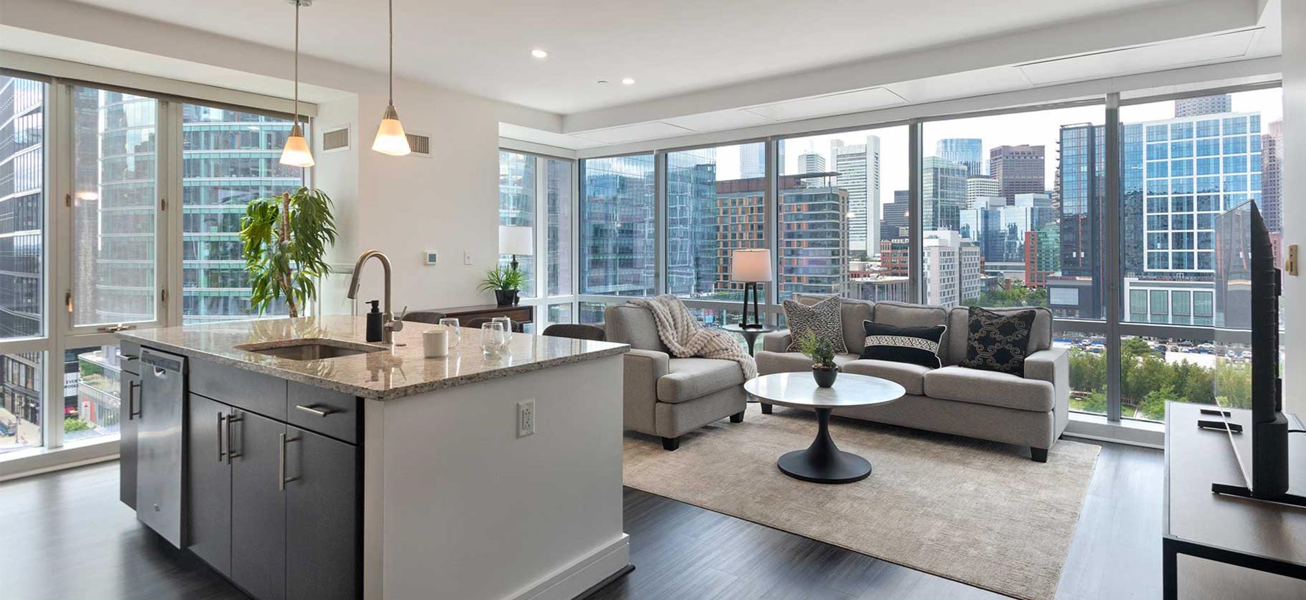 100 Pier 4 penthouse kitchen and living room with beautiful views of the city