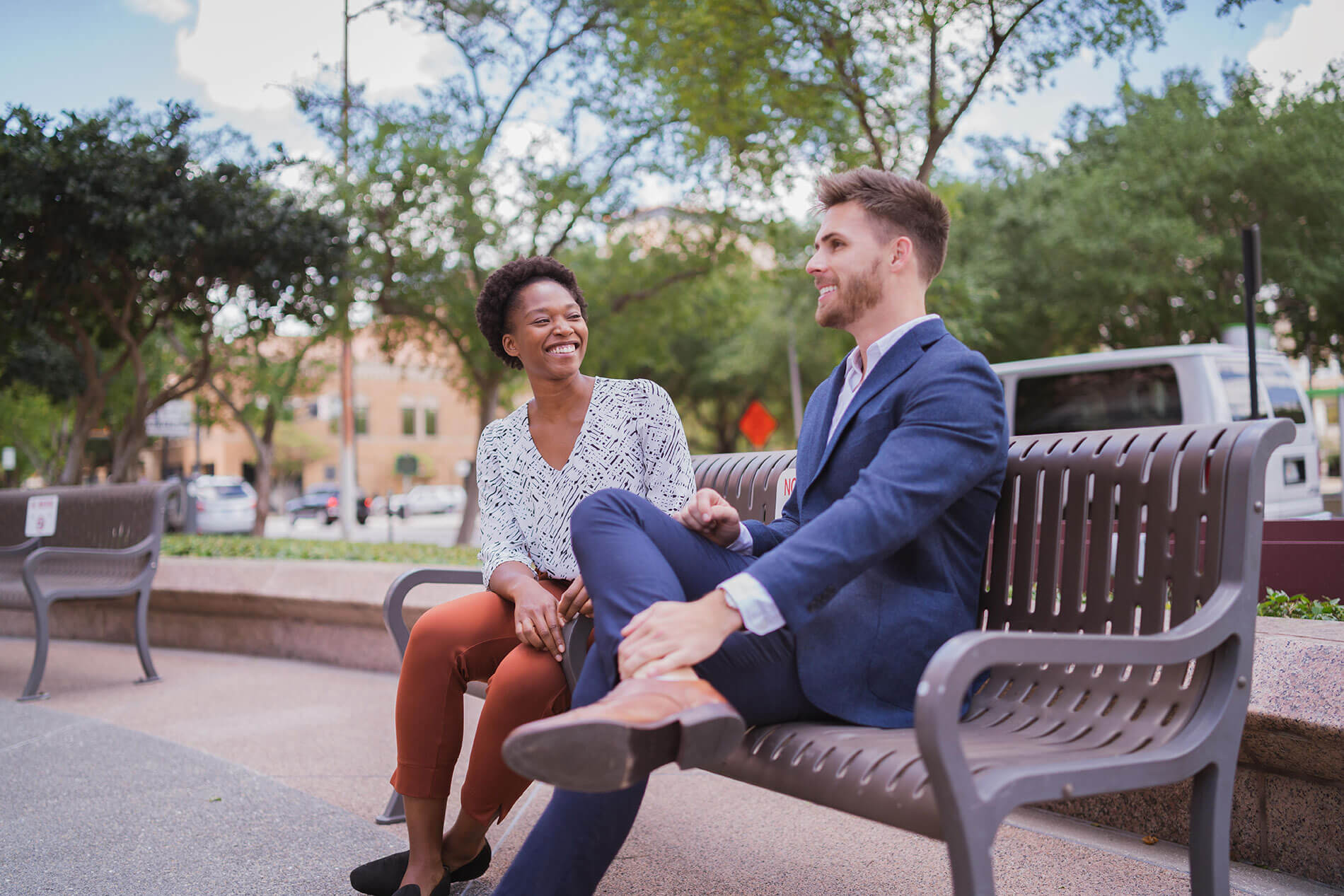 101 N. Meridian man and woman in business attire talking on a city bench