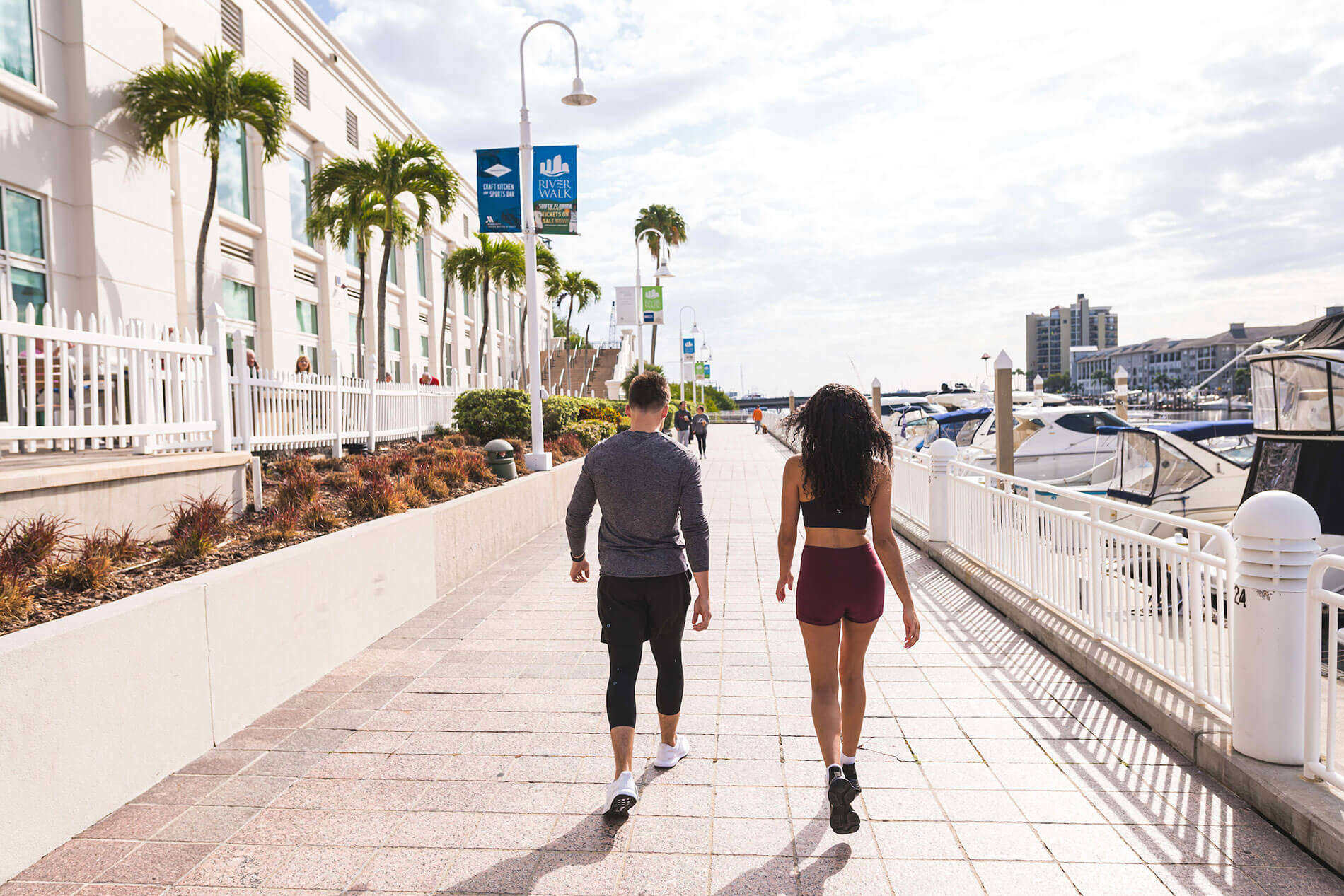 101 N. Meridian man and woman in workout attire walking along the riverwalk