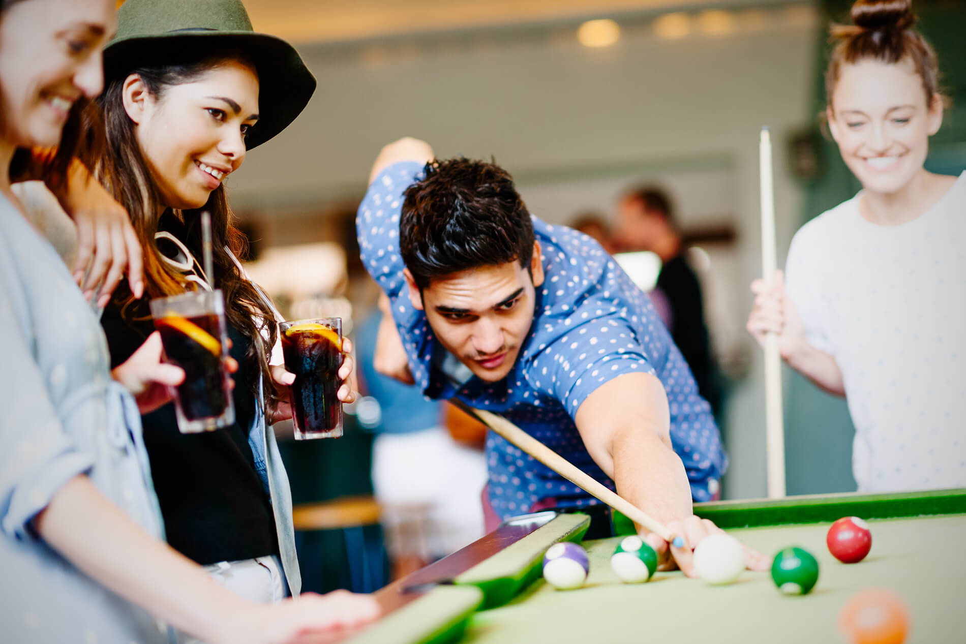 Friends playing billiards