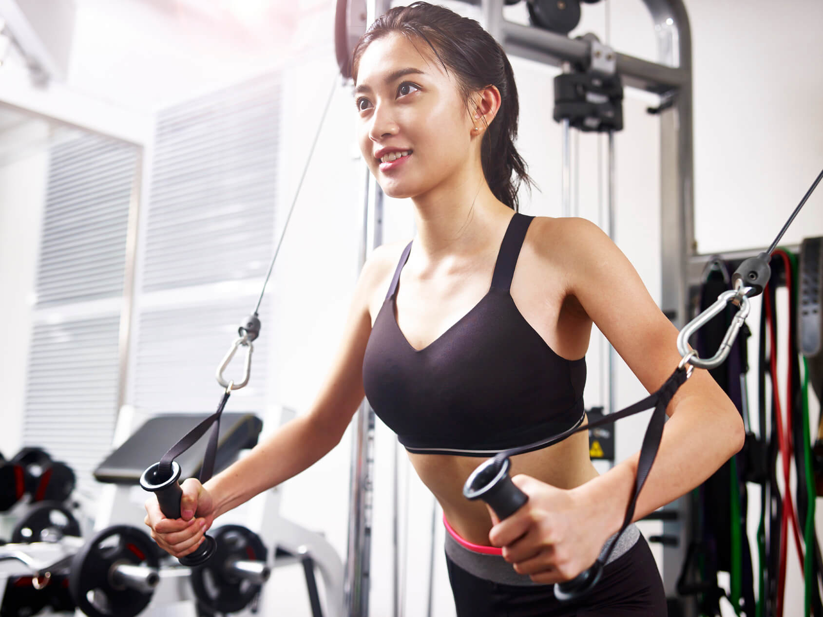 Woman exercising on weight machine