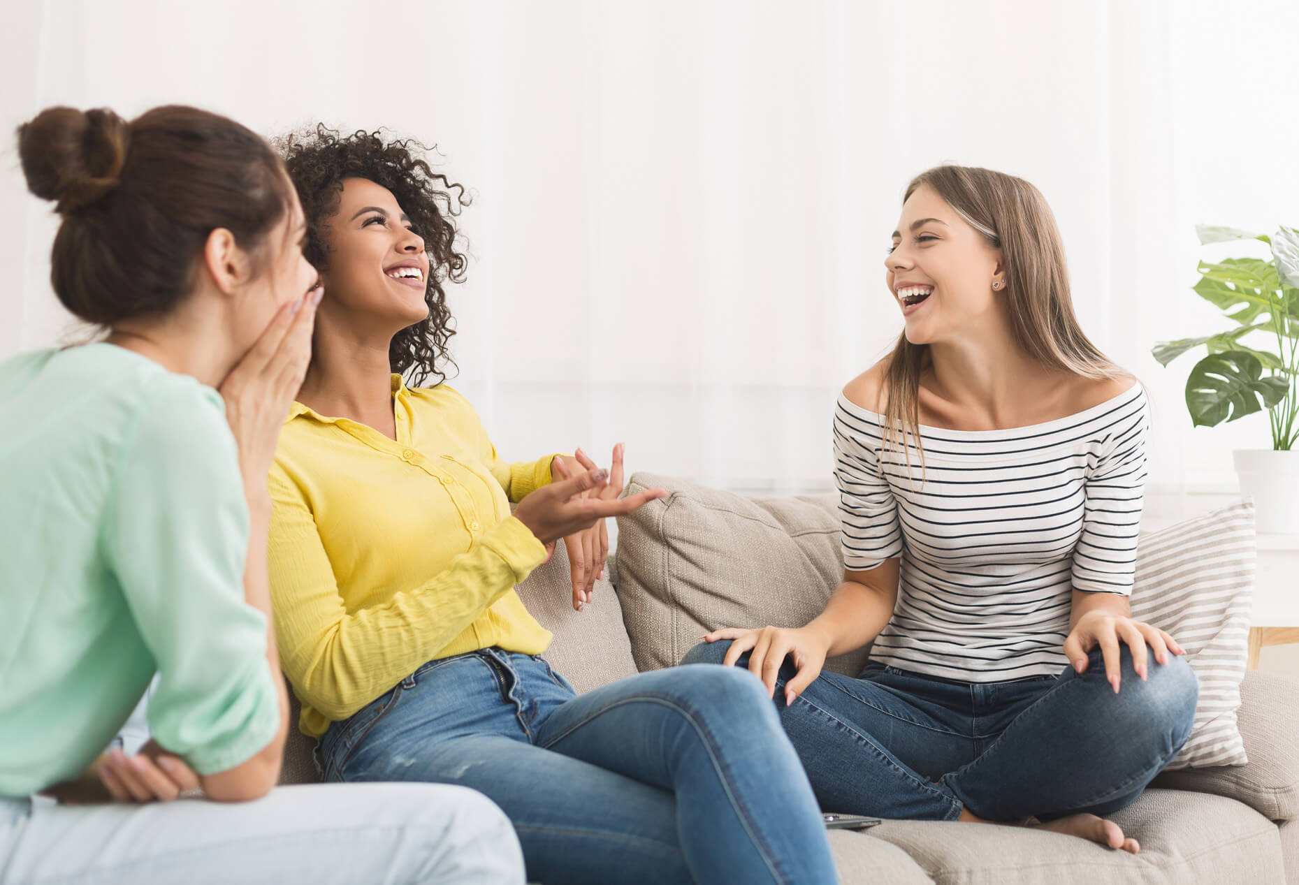 Friends sitting on the couch talking