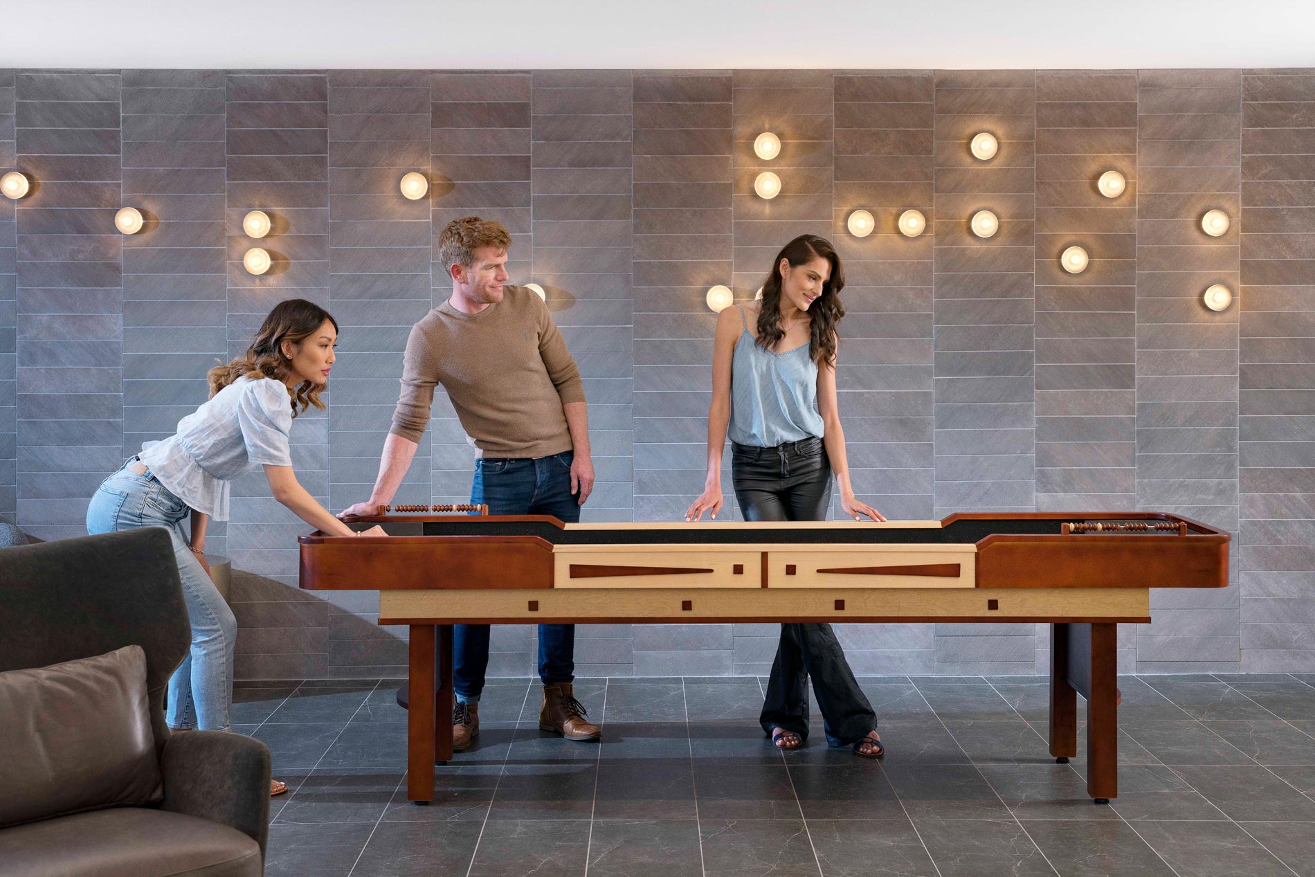 5421 Dublin Three people play shuffle board in clubhouse