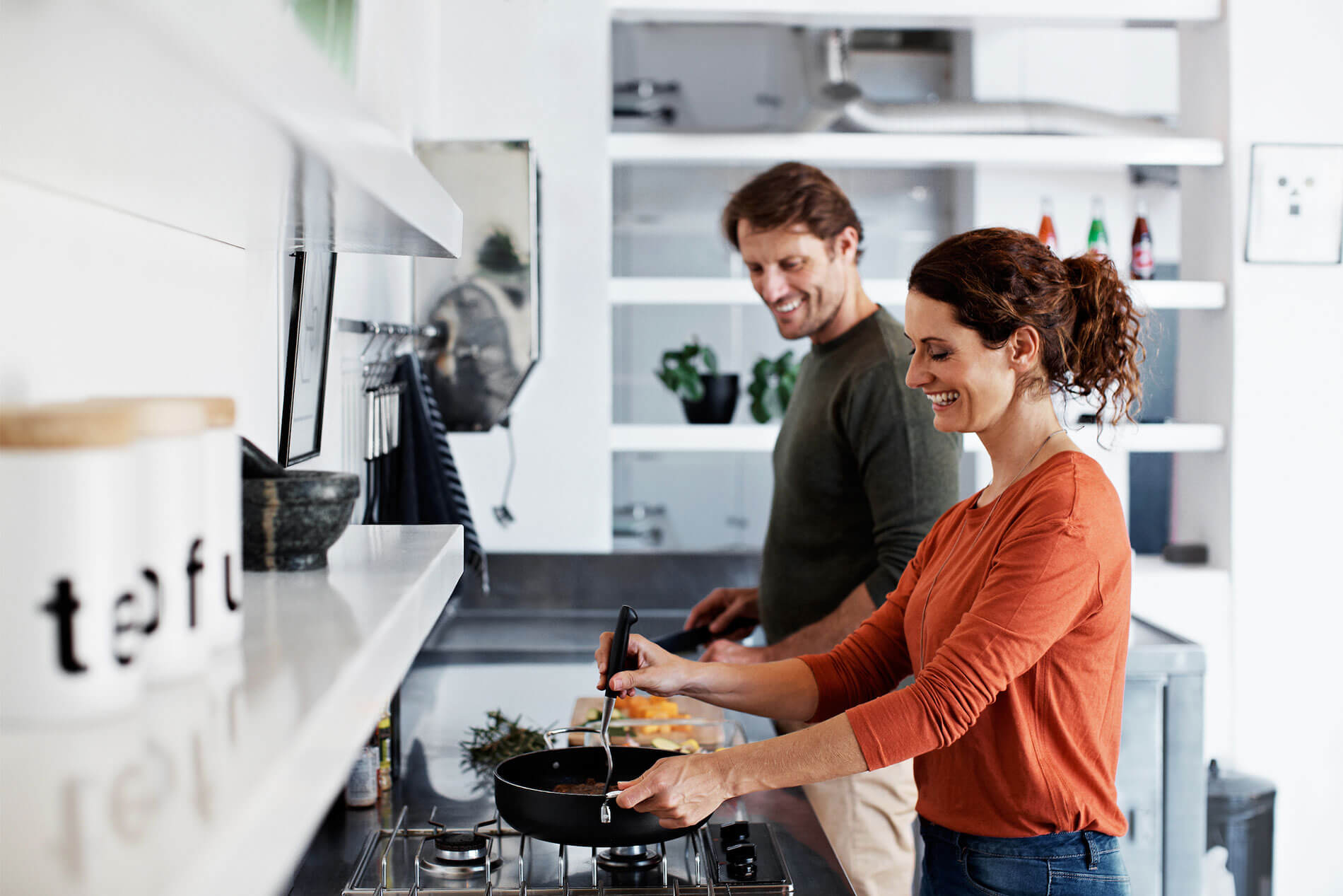 Couple in kitchen cooking together