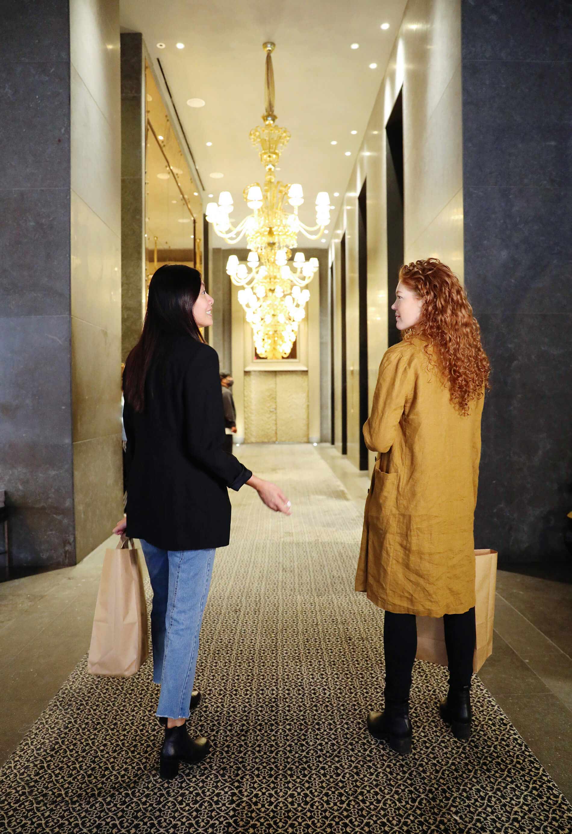 Friends walking into the 95 Wall lobby