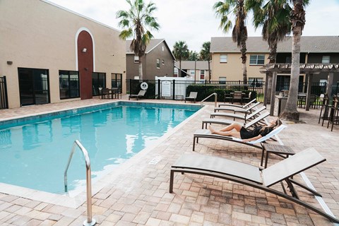 Alafaya Woods woman sits by pool
