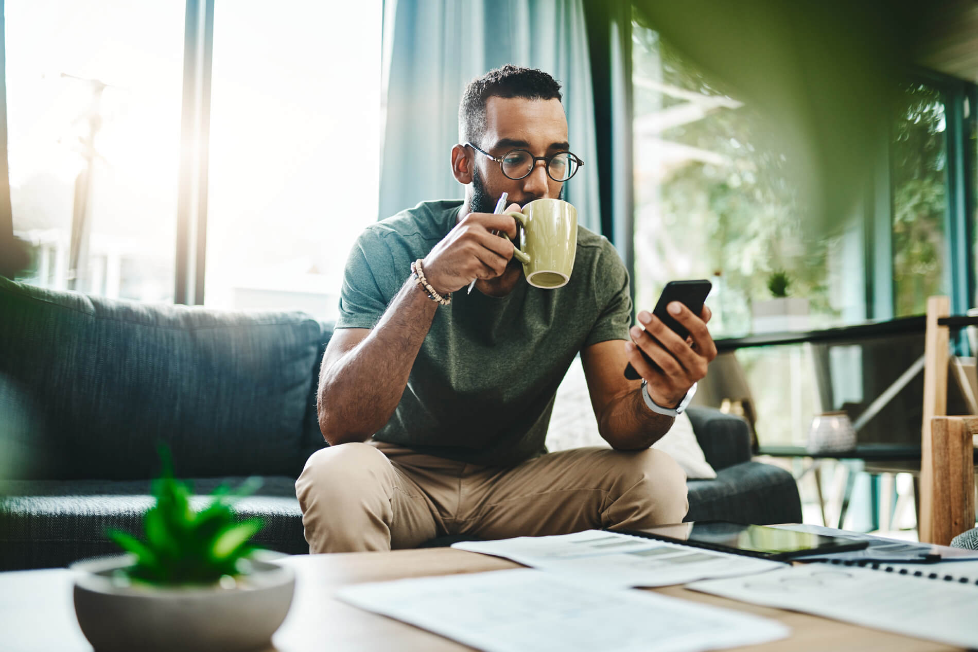 Man sitting on the couch drinking coffee