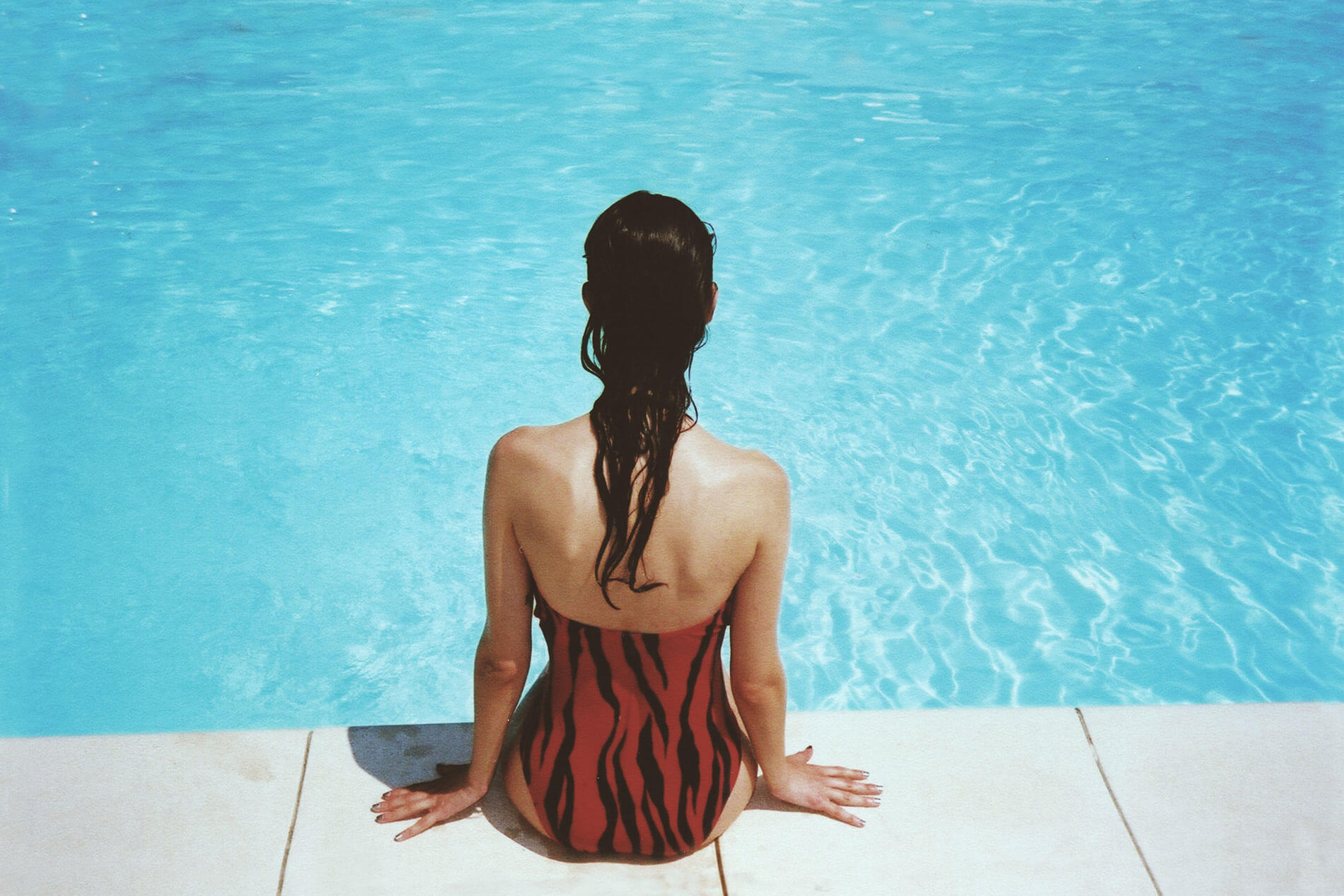 Woman sitting by pool