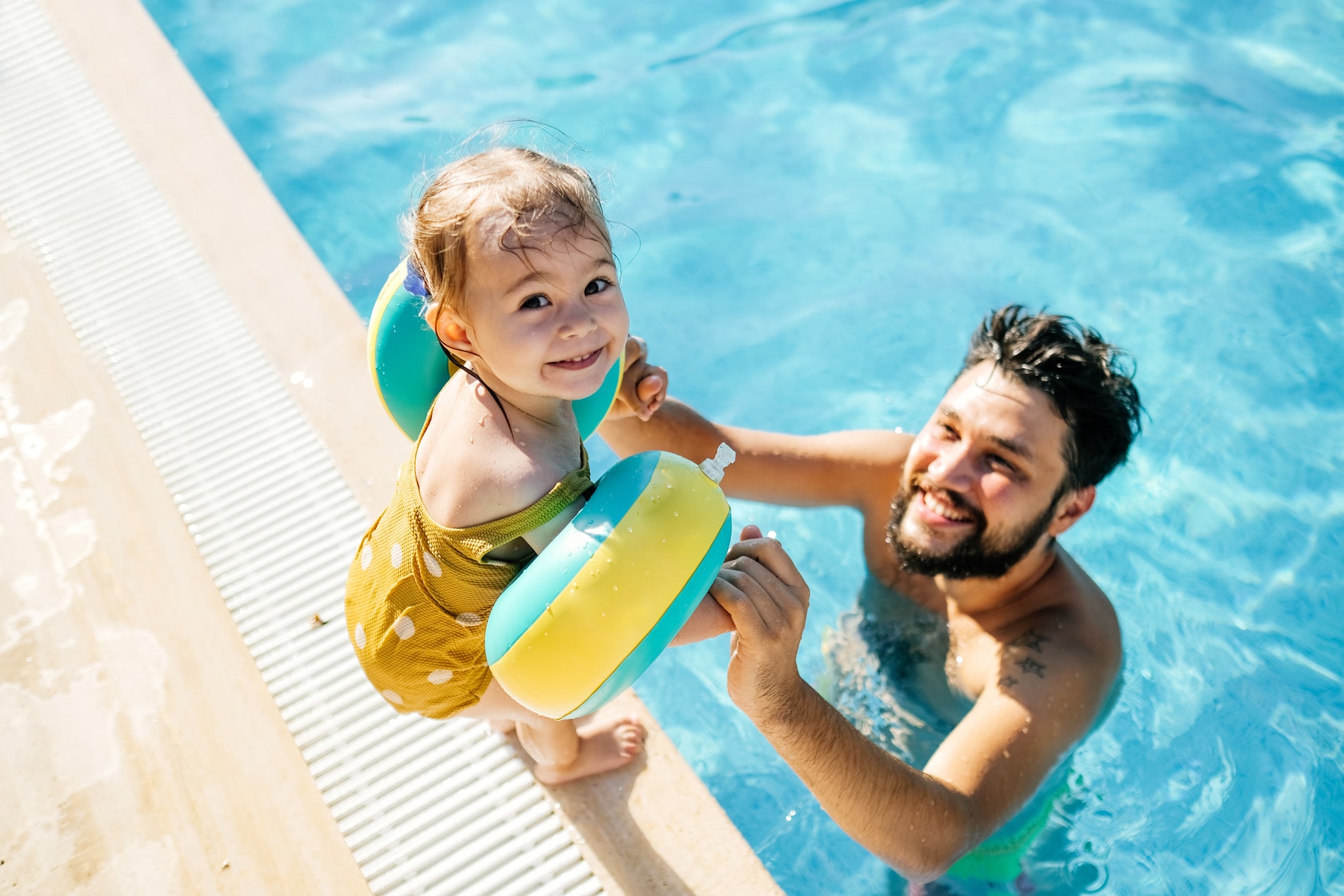 Man and child in swimming pool