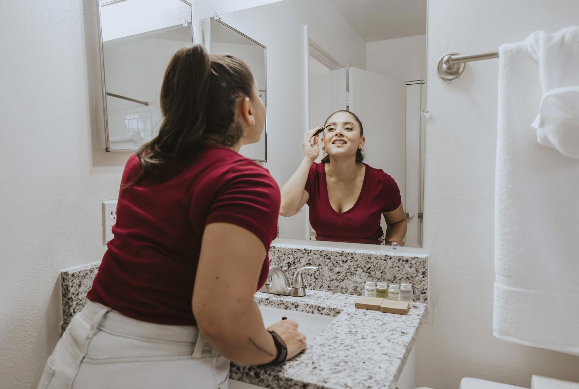 Arbors Lee Vista woman does make-up in bathroom