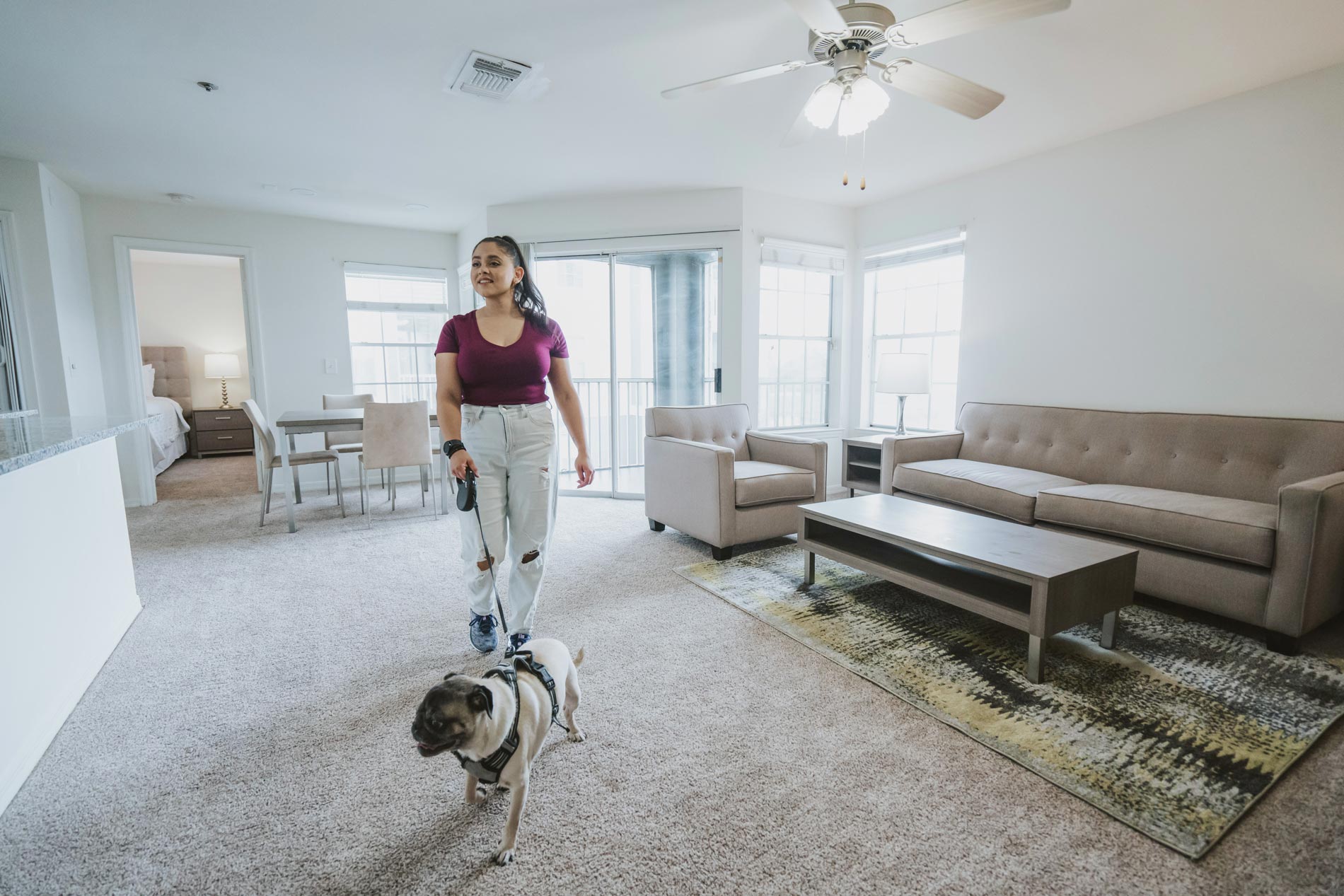 Arbors Lee Vista woman walks out of staged unit with dog