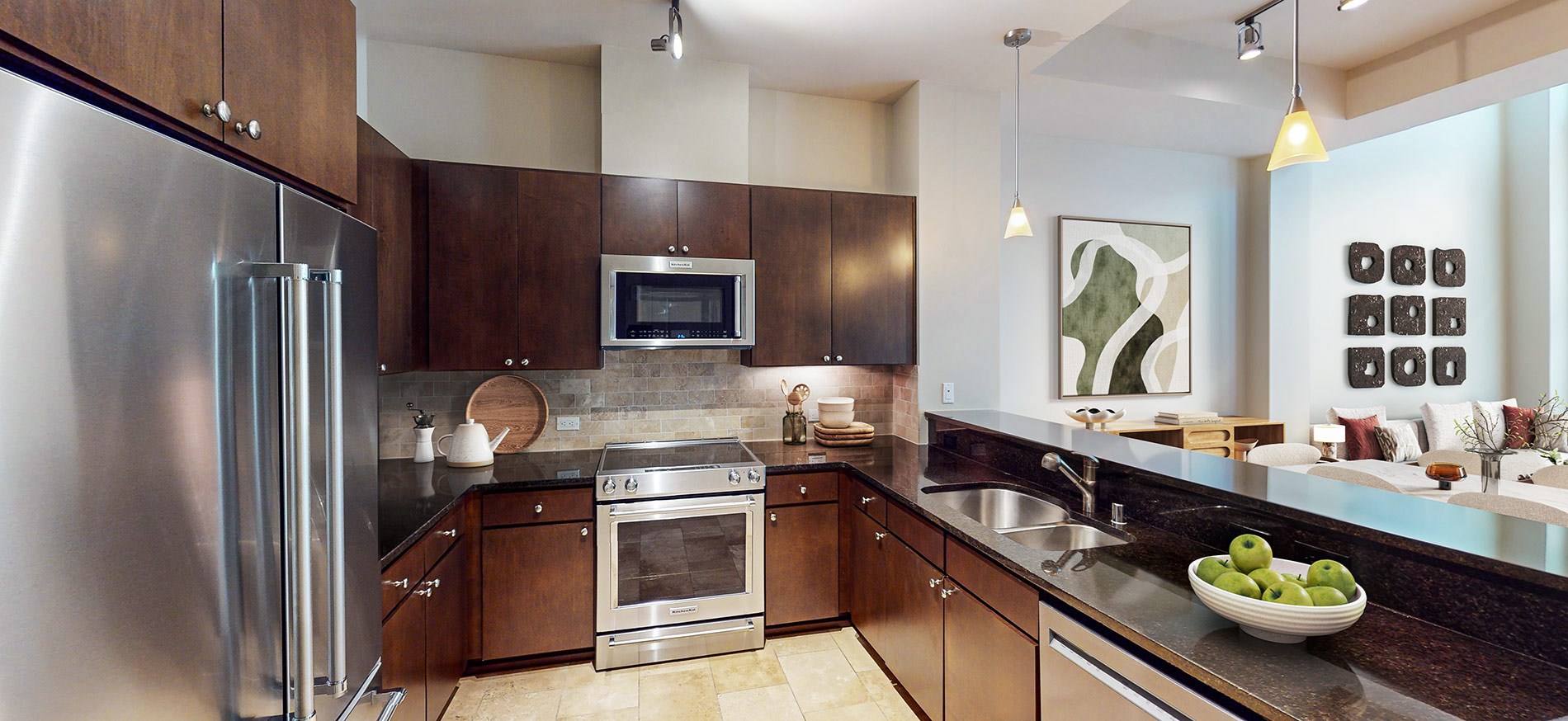 Upscale kitchen at Ashton Bellevue apartments in the Bellevue neighborhood of Seattle features stainless steel appliances