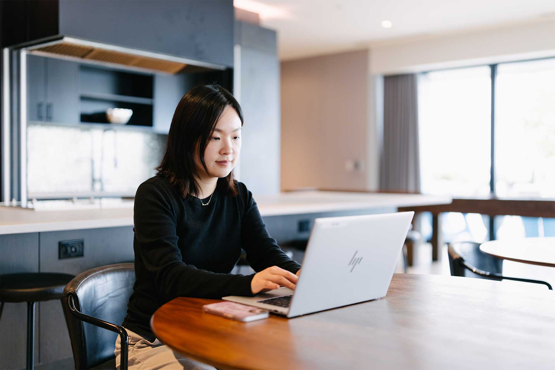 Woman on laptop in lounge