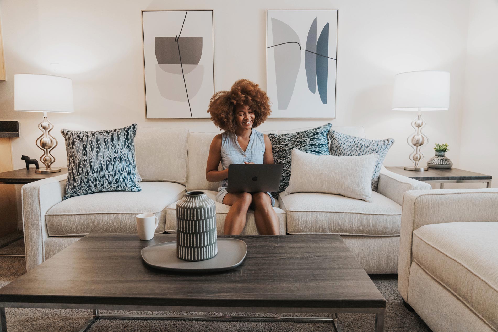 Cambridge Woods woman works on laptop in living room