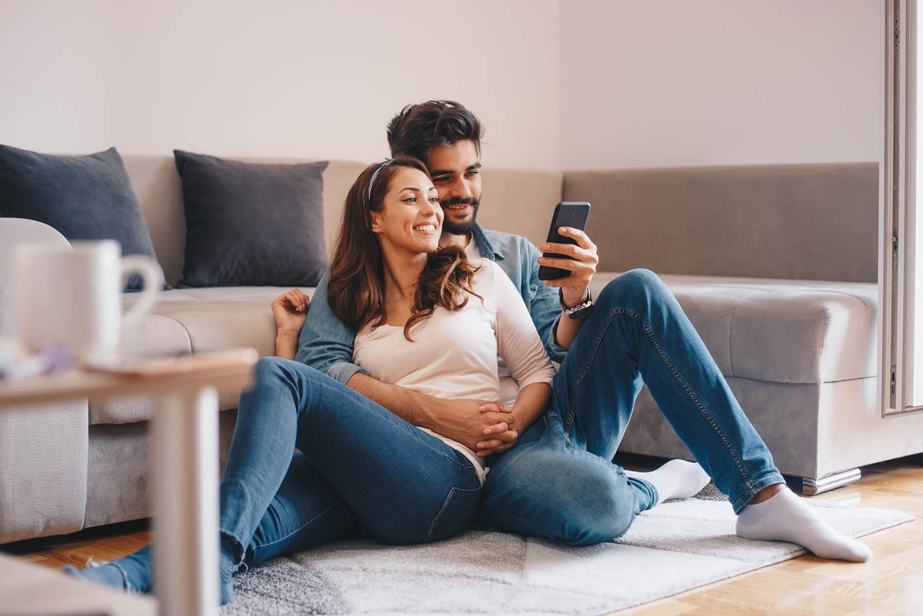 Man and woman lounging on living room floor