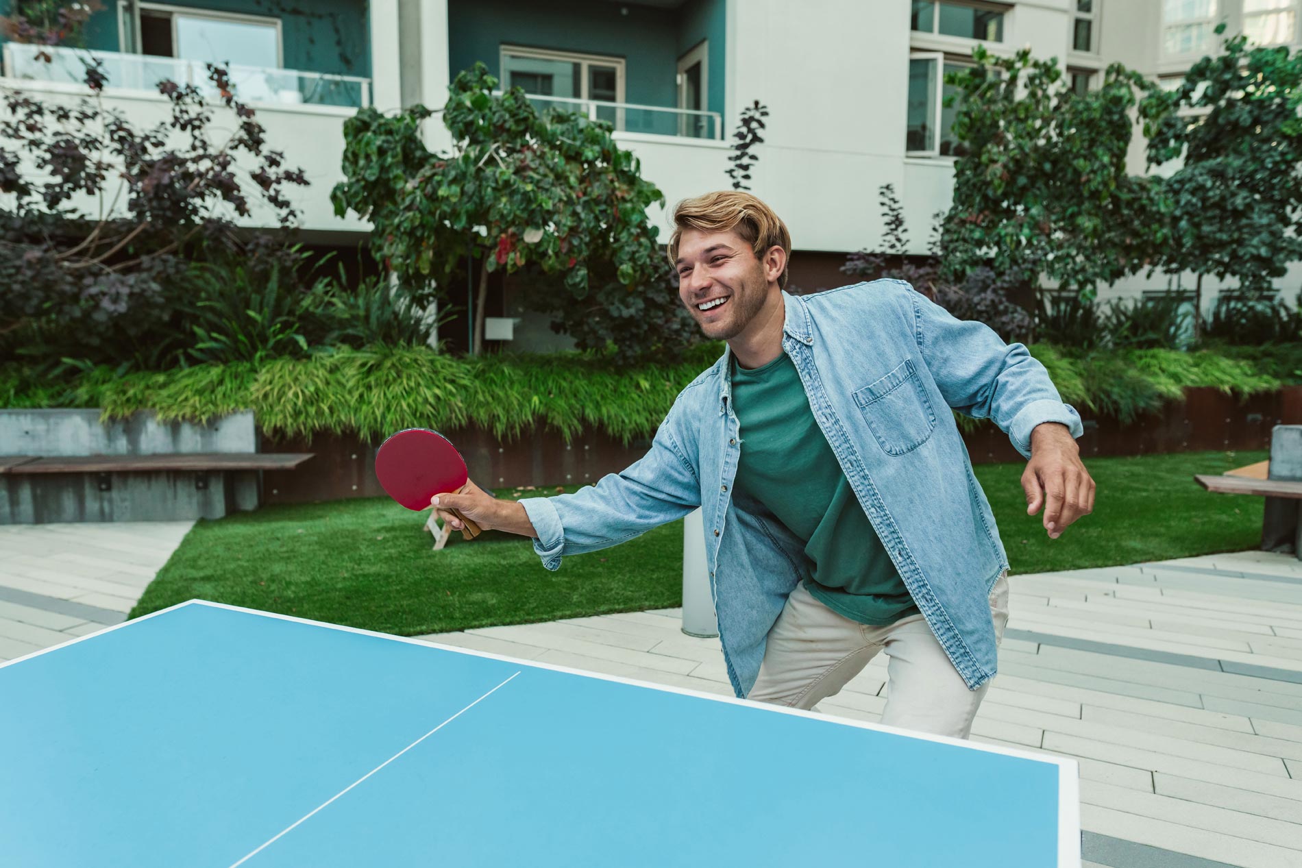 Channel Mission Bay man playing ping pong in courtyard