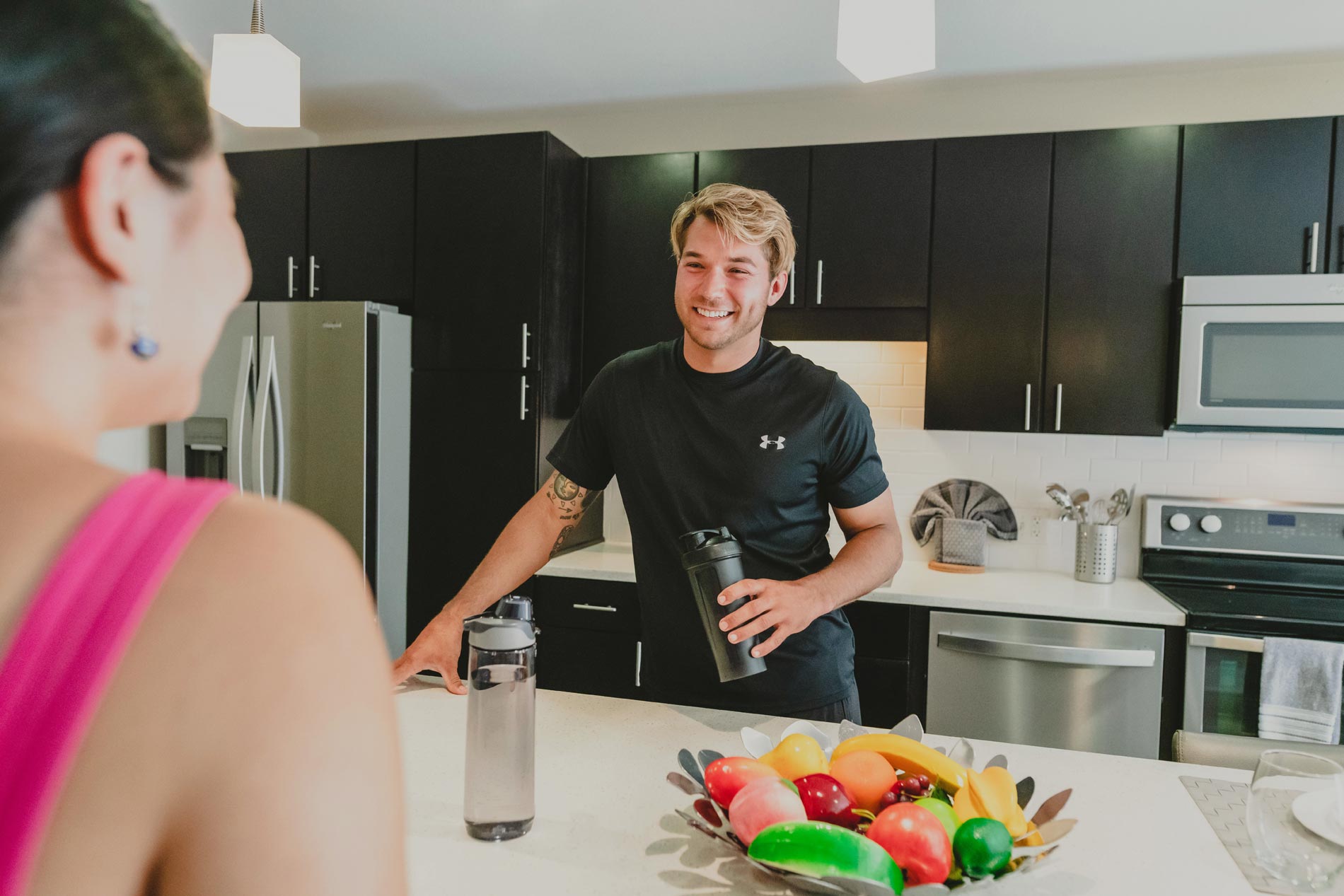 Channel Mission Bay man and woman taking in apartment kitchen