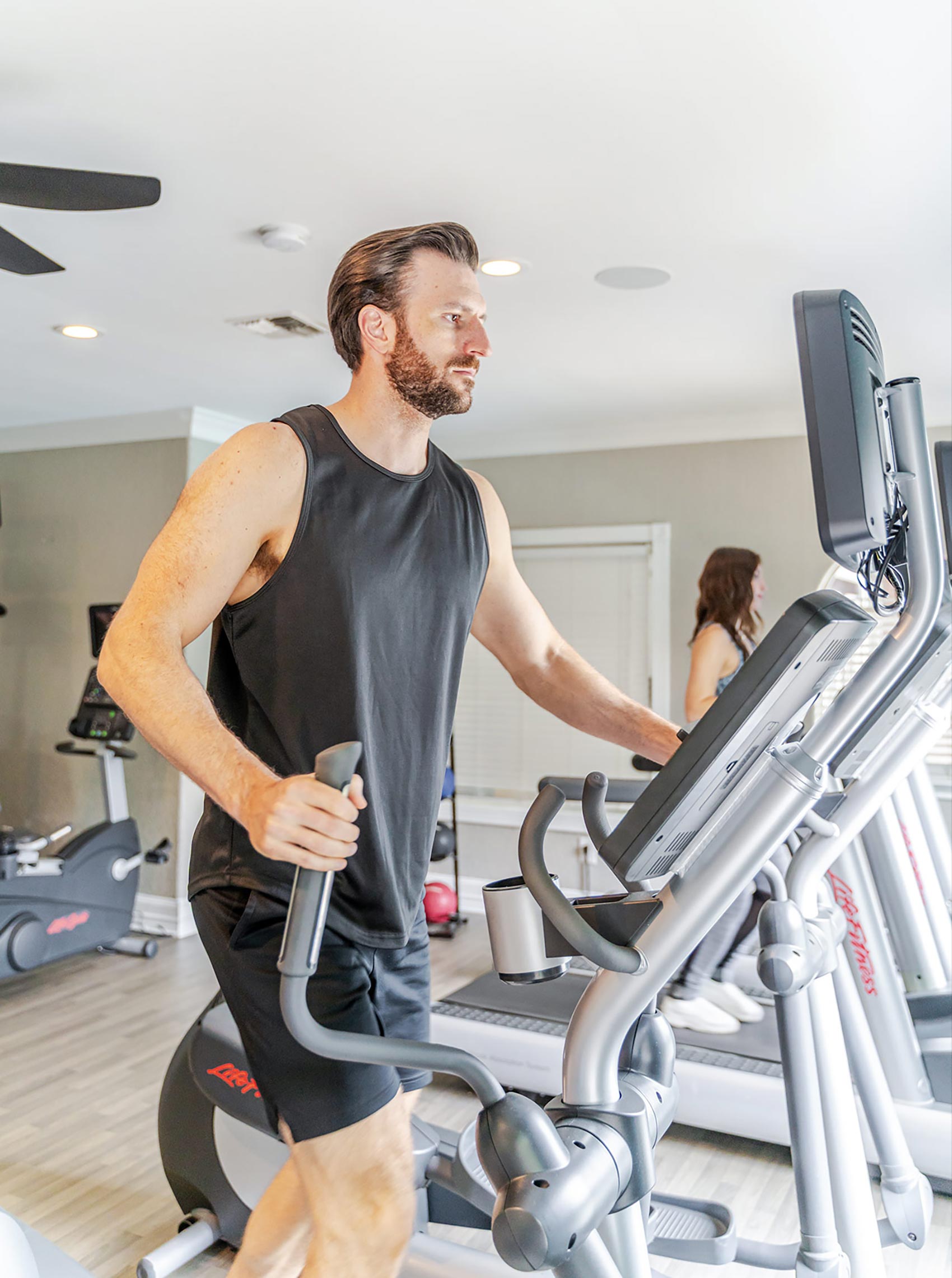Colonnade man exercises on elliptical machine