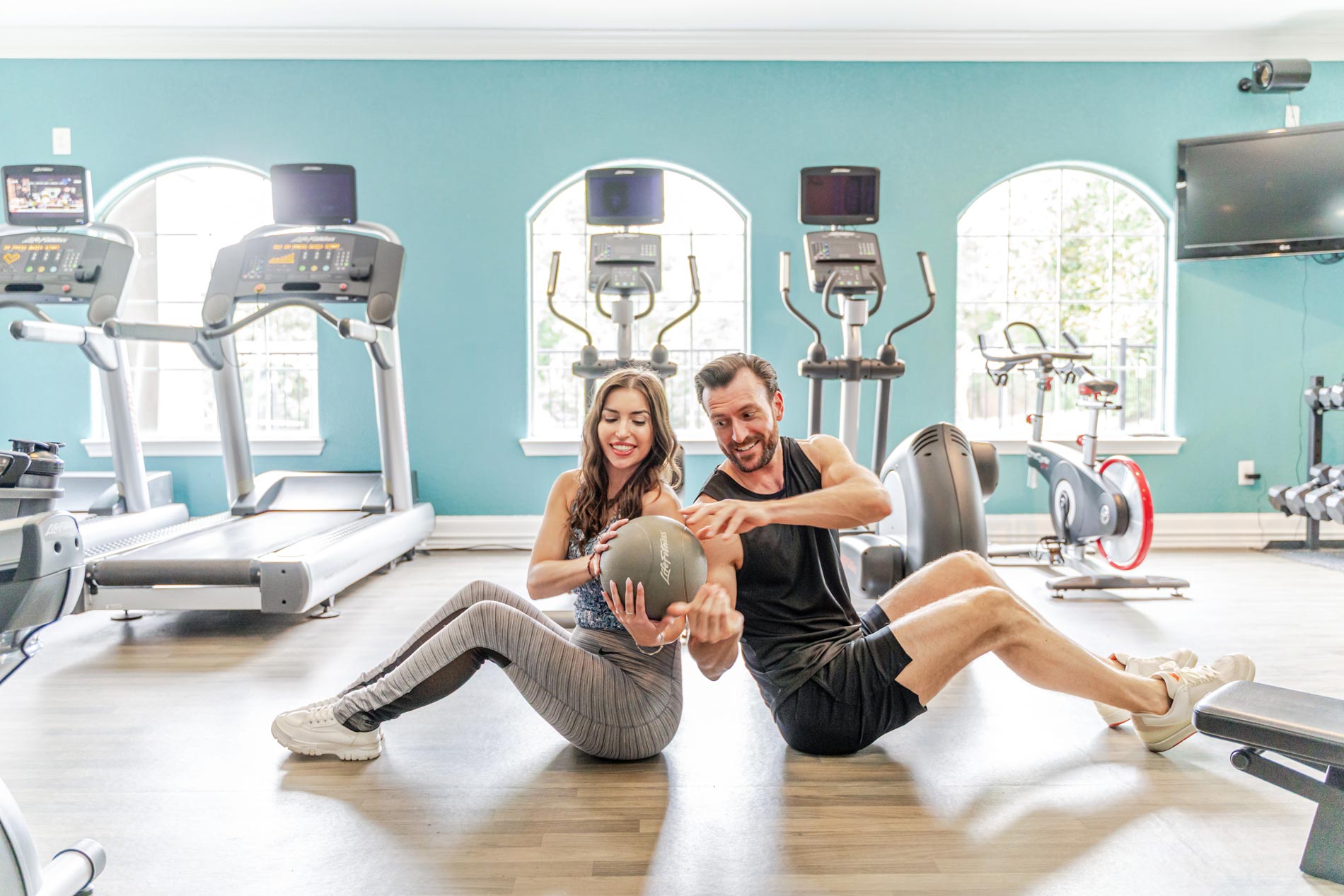 Colonnade man and woman pass a medicine ball