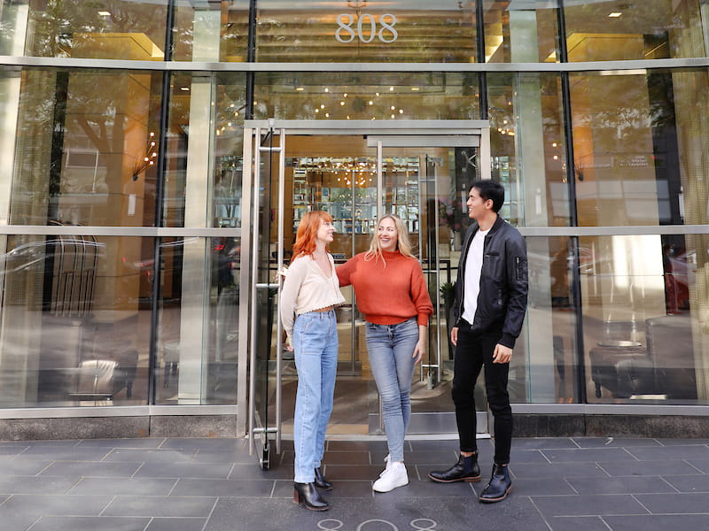 Three people touring Columbus Square on the Upper West Side