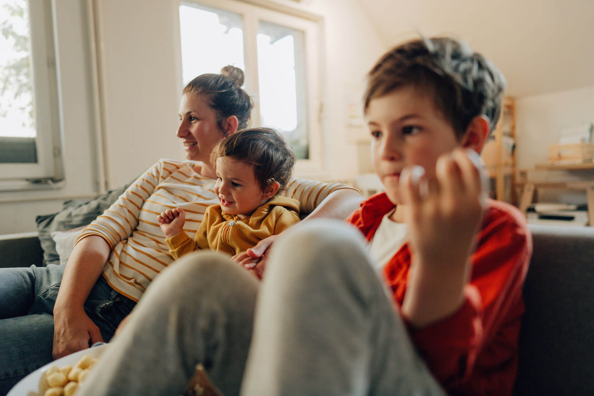 Mom and two children sitting on couch
