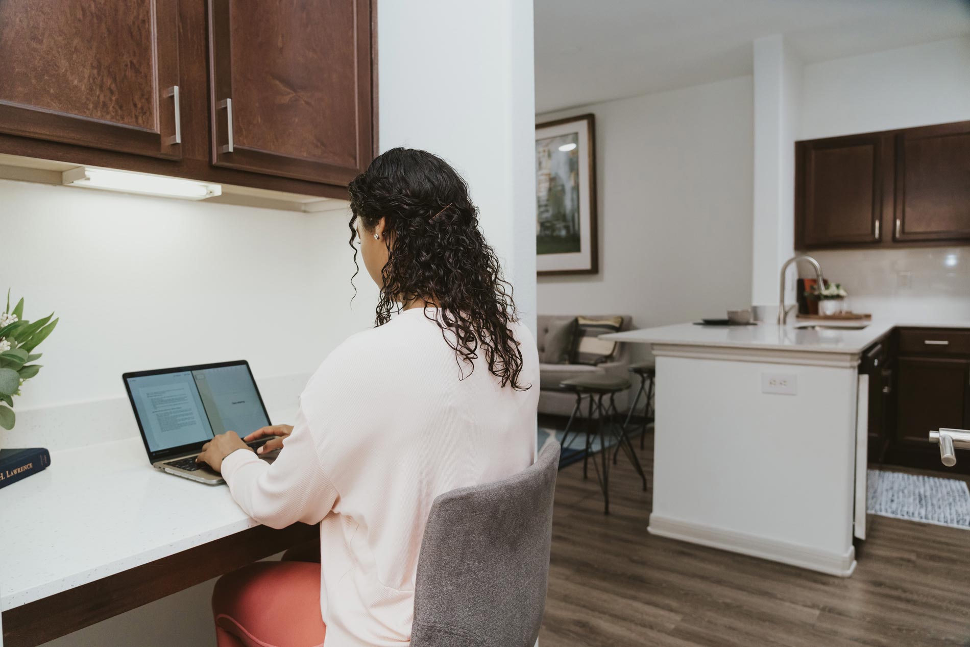 Cool Springs woman works on laptop in unit office