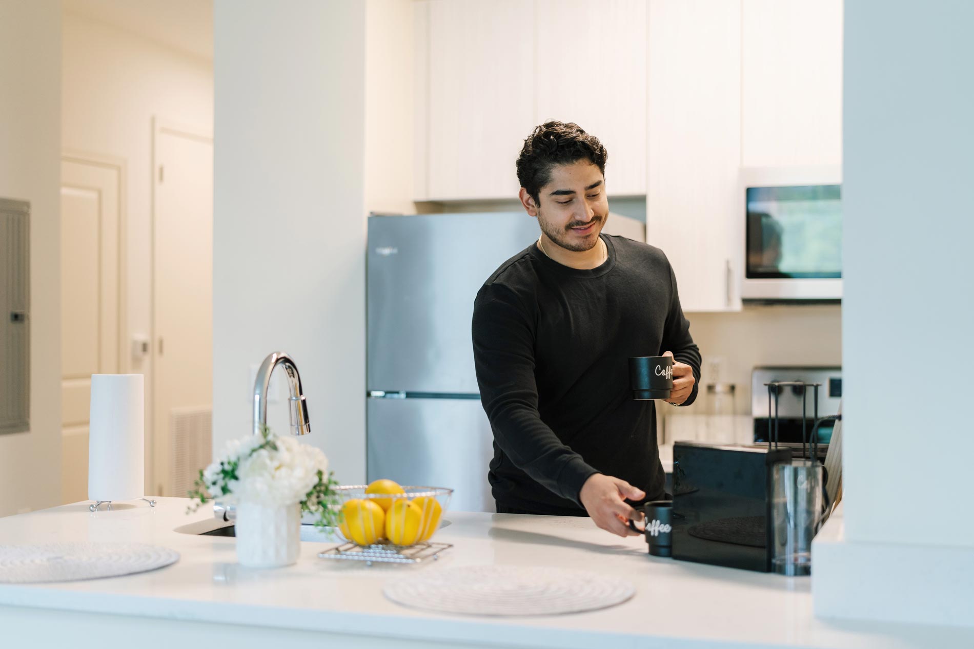 Delancey at Shirlington Village Apartments Man in Kitchen