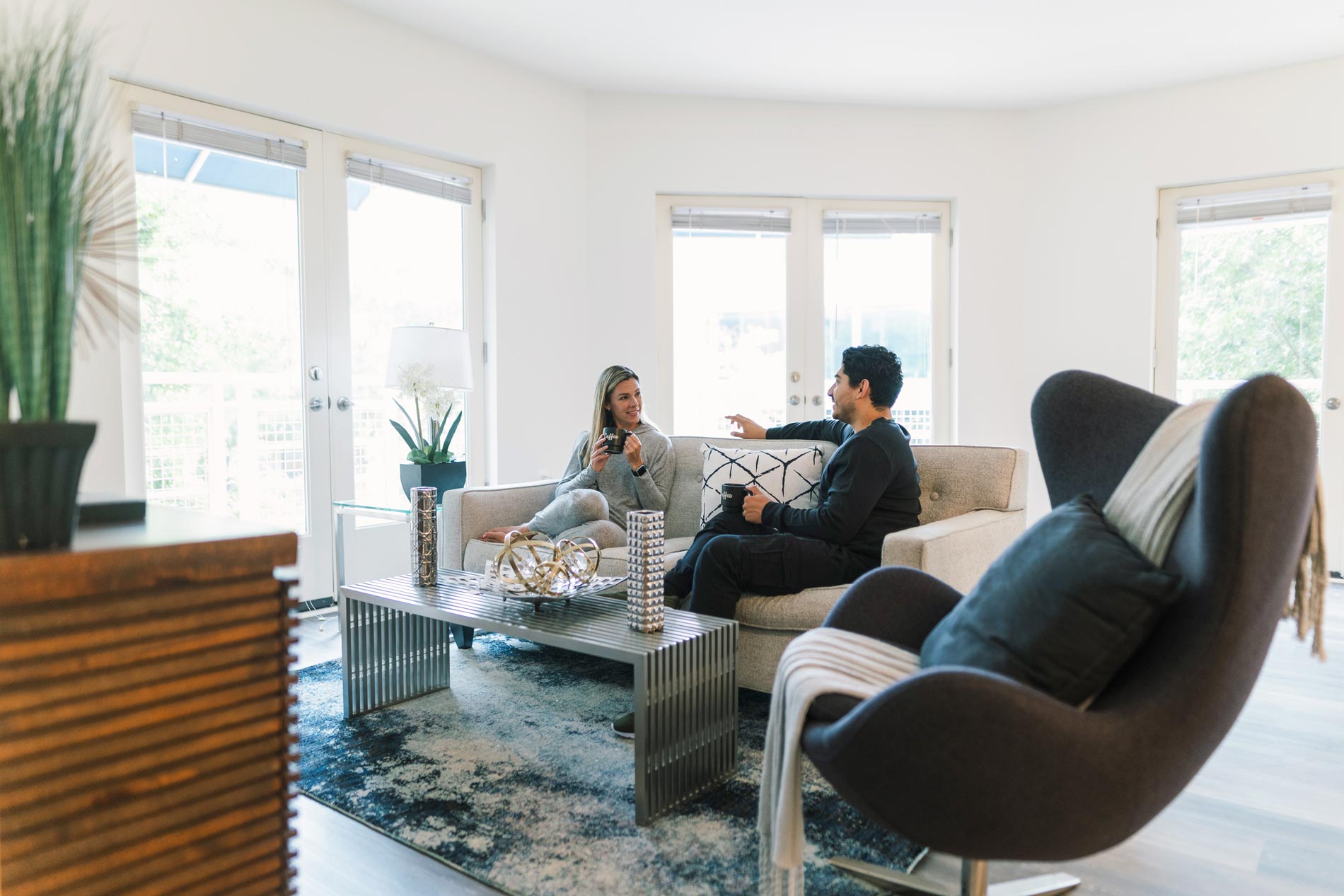 Delancey at Shirlington Village Apartments man and woman sitting on couch