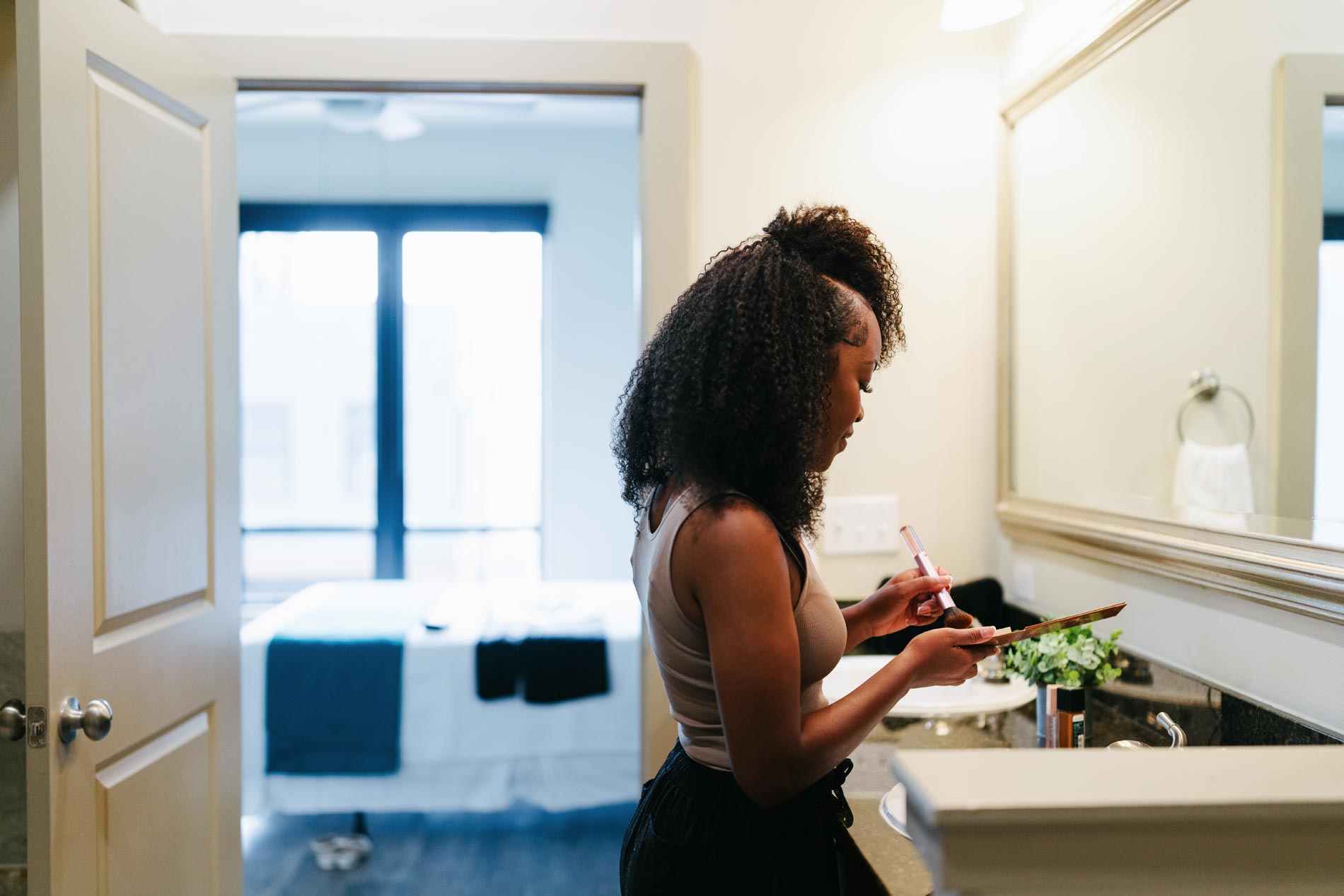 Domain Brewers Hill woman gets ready in bathroom