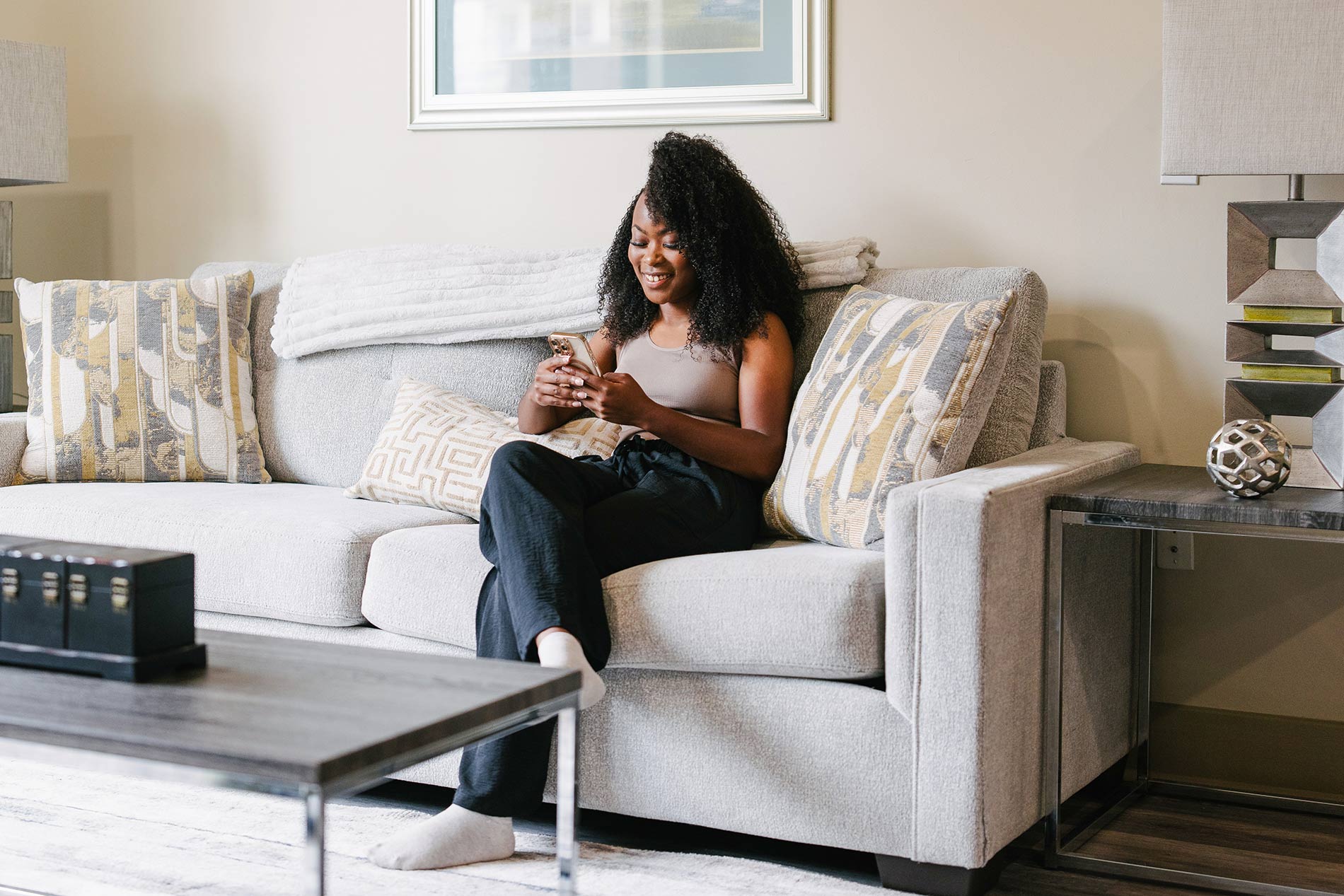 Domain Brewers Hill woman sits on living room couch