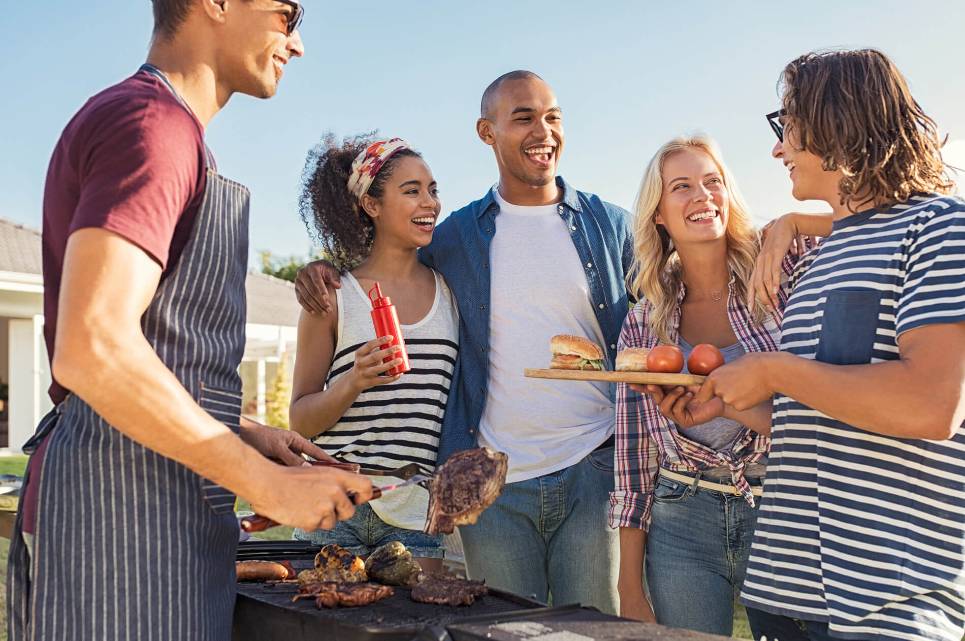 Friends outside BBQing