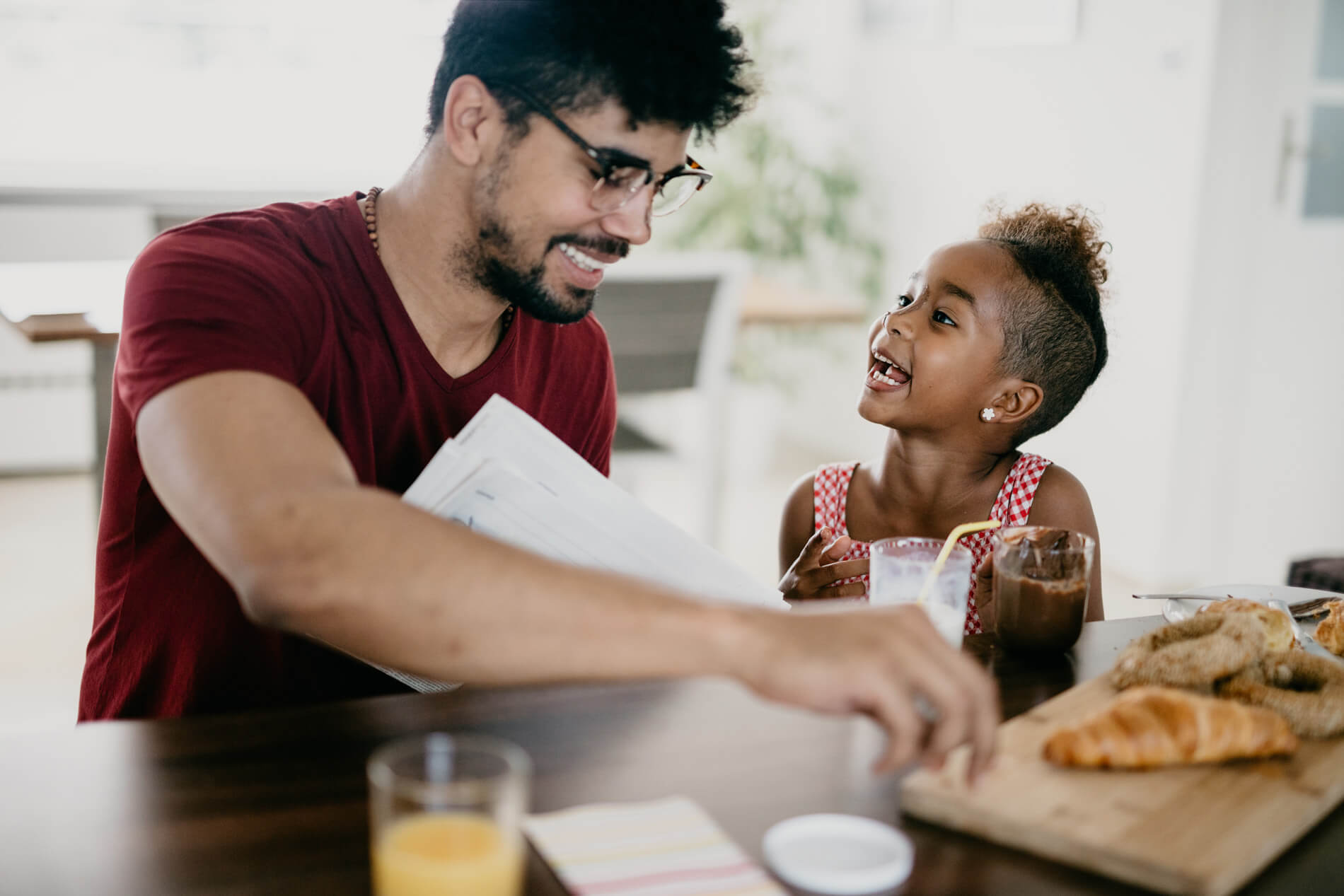 Man eating breakfast with child