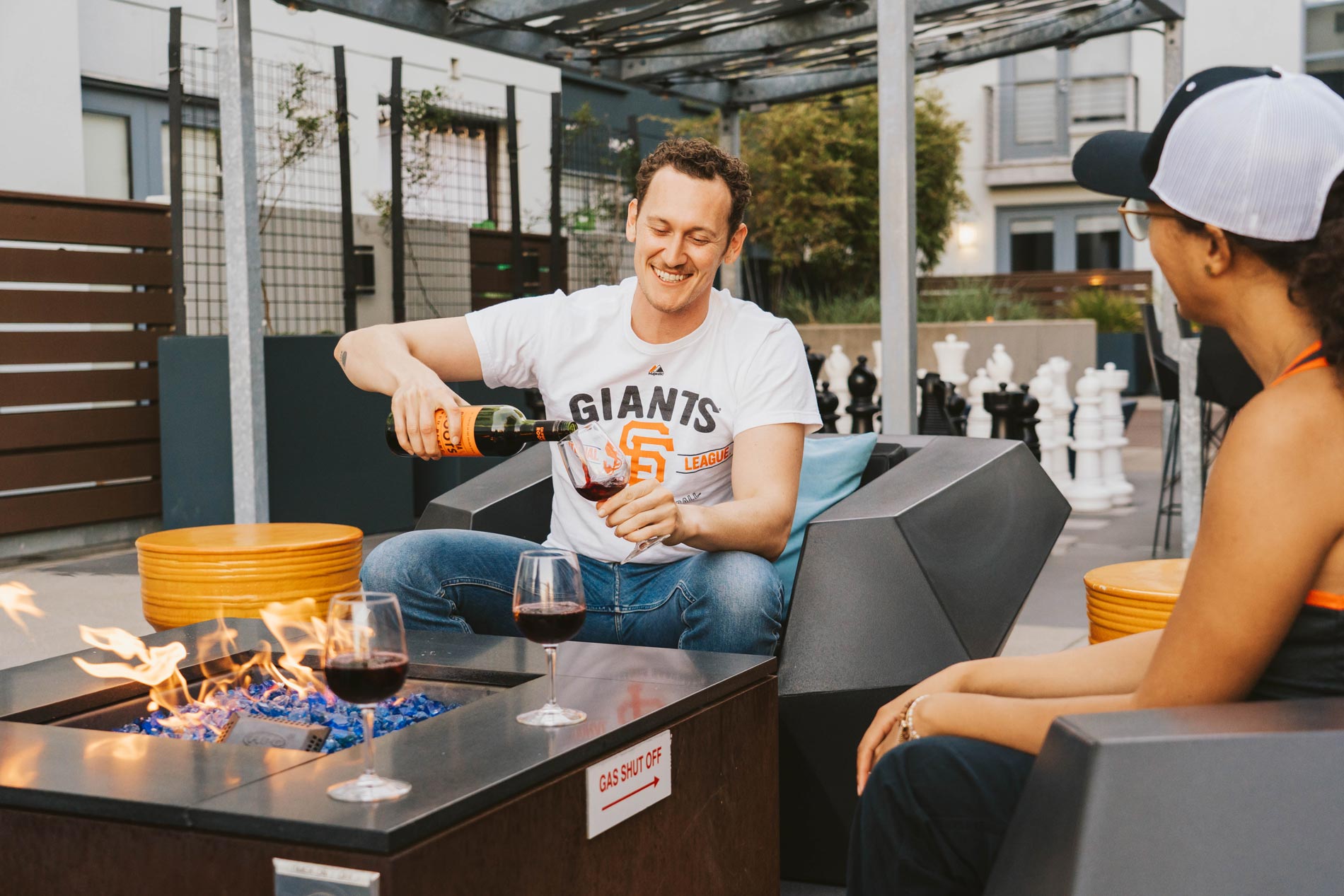 Edgewater two people by fire pit