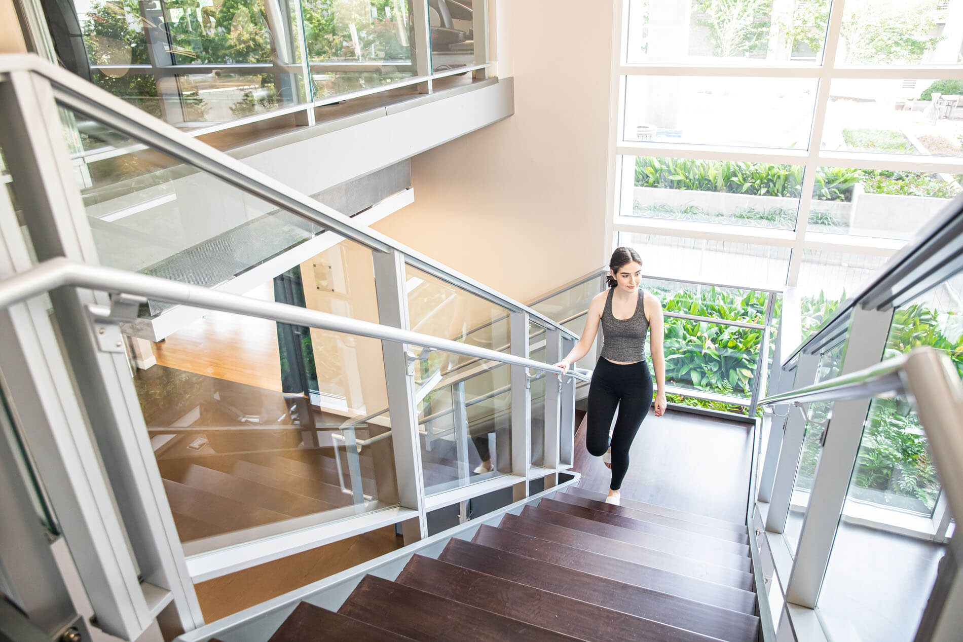 Woman walking up stairs in gym