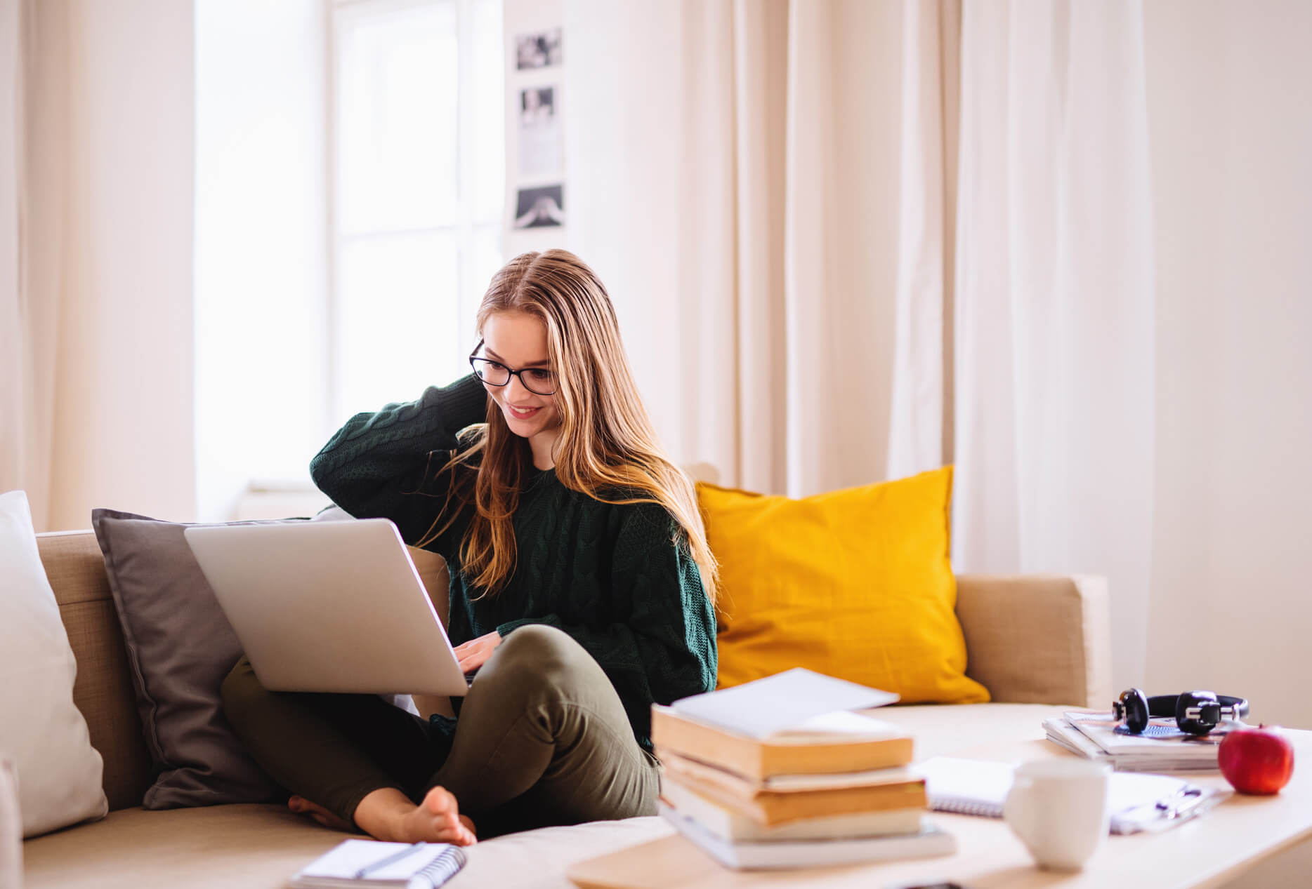 Woman sitting on the couch on her laptop