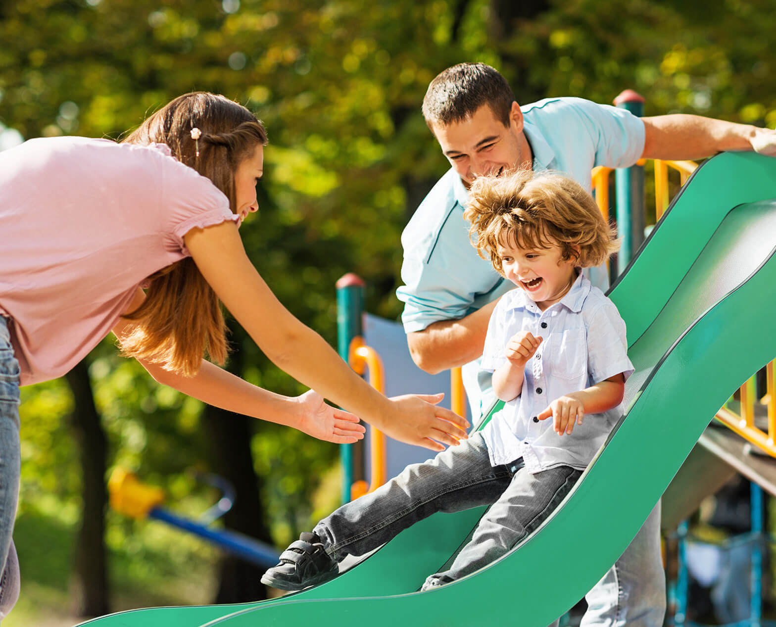 Boy sliding down a playground slide
