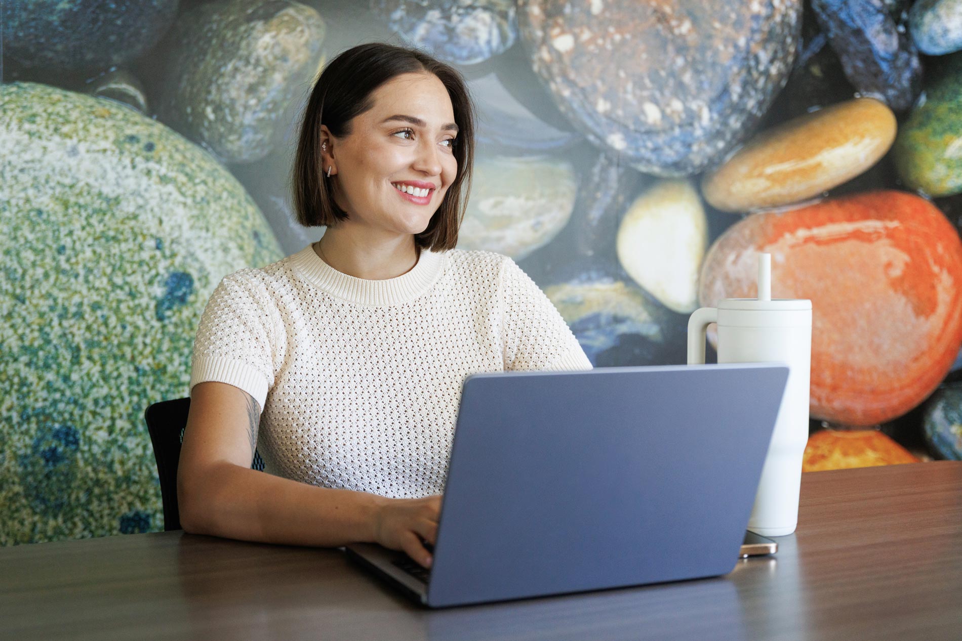 Hilltop woman works on laptop in clubhouse 