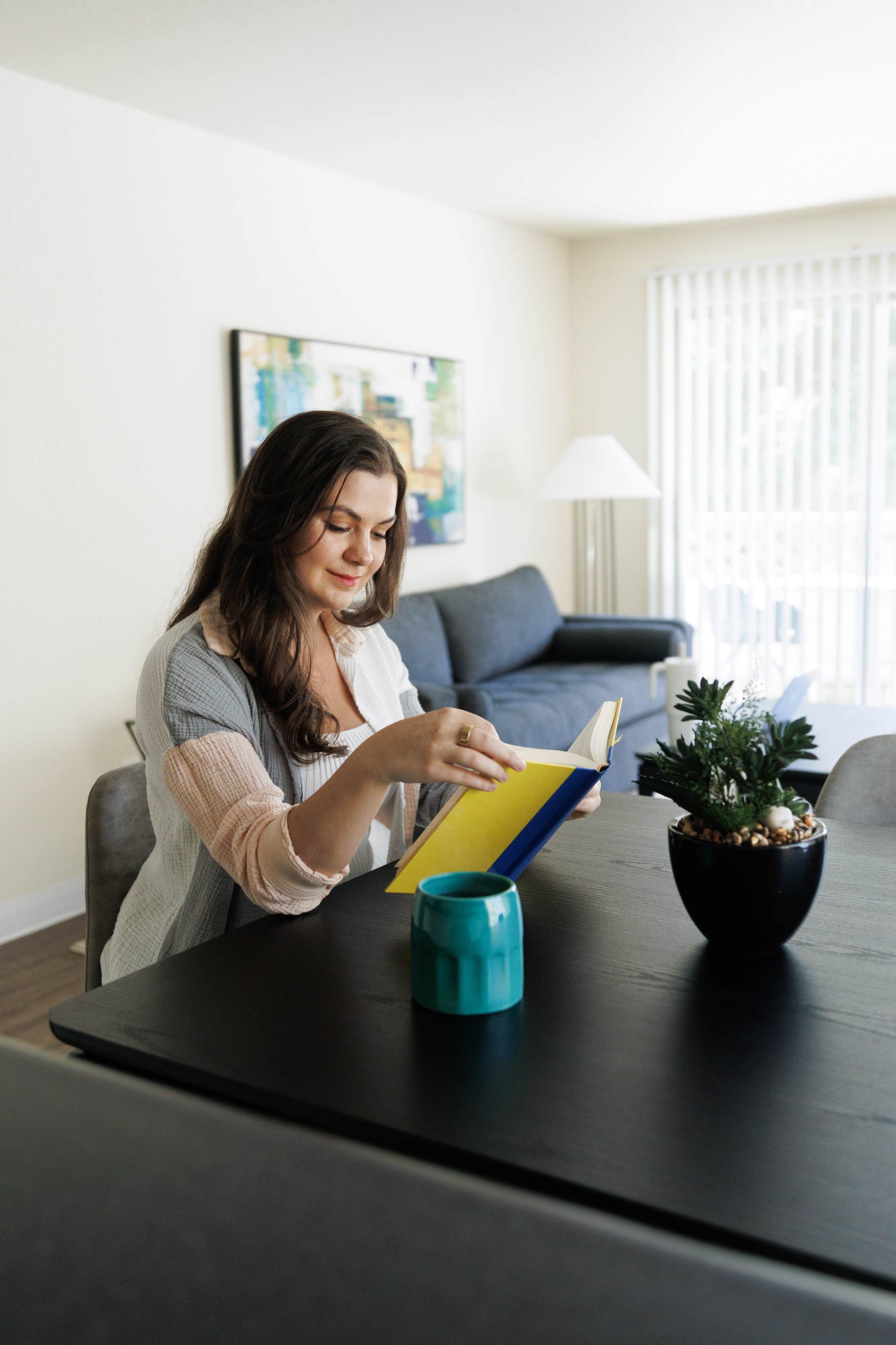 Hilltop woman works on laptop at dining room table