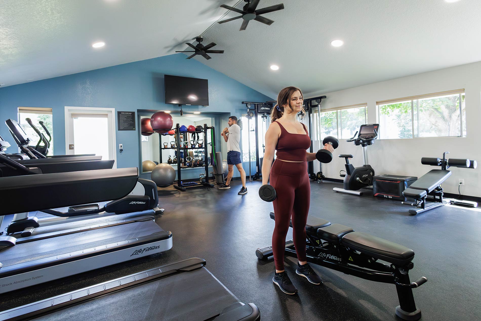 Hilltop man and woman in fitness center