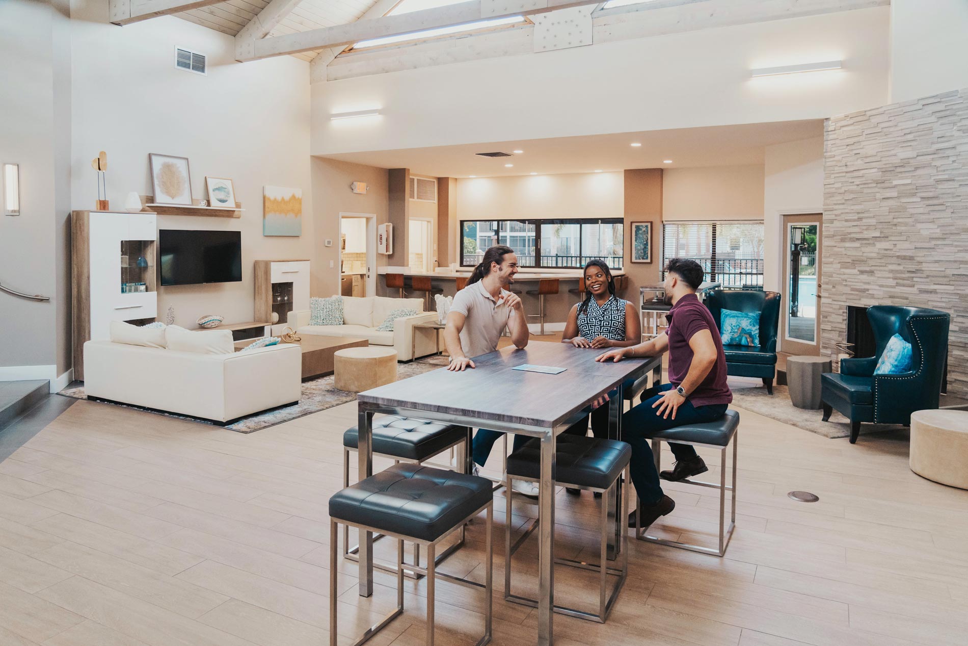 Inlet Bay three people sit in clubhouse