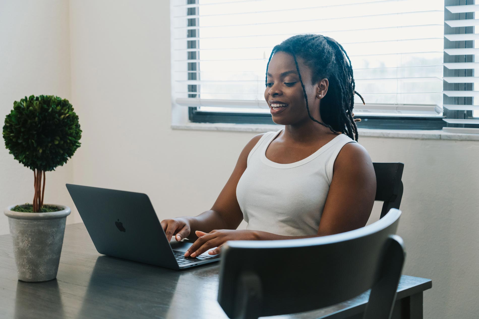 Inlet Bay woman works on laptop in dining room