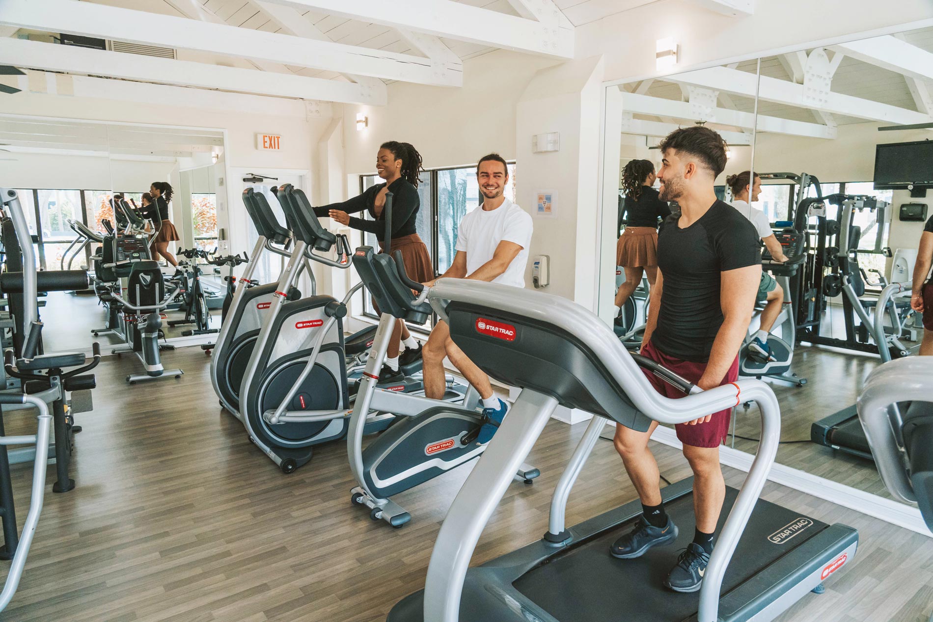 Inlet Bay three people exercise in fitness center