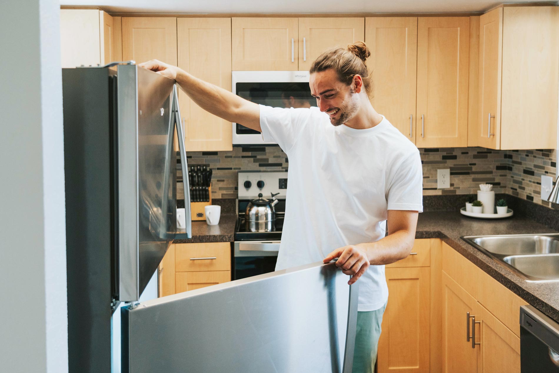 Inlet Bay man looks in refrigerator in kitchen
