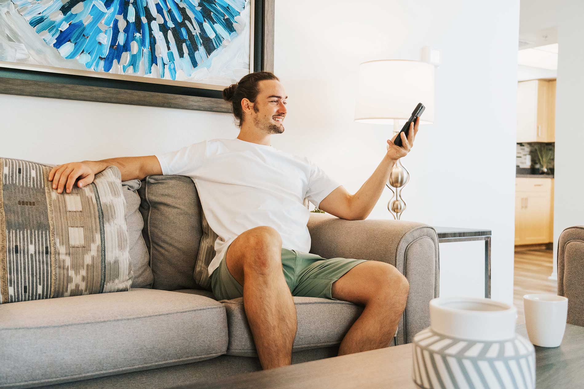 Inlet Bay man sits on couch with phone